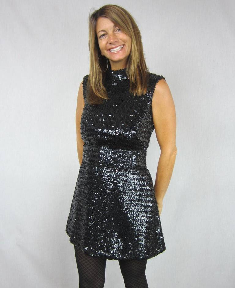 Black sequins top to bottom on this ultra Mod Victor Costa pantsuit. The surface of both pieces are entirely covered with glossy black sequins giving the set an almost liquid feel. The Top can be worn as a dress, zippers down the back, Belt with two