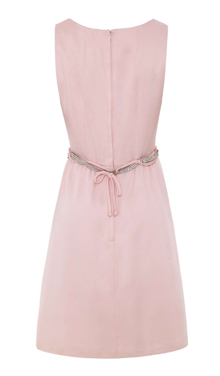 This lovely 1960s silk satin shift dress in pale pink is an early piece from American designer Victor Costa and maintains a beautiful balance of style and formality for which its designer is renowned. The thick satin fabric is expertly tailored with