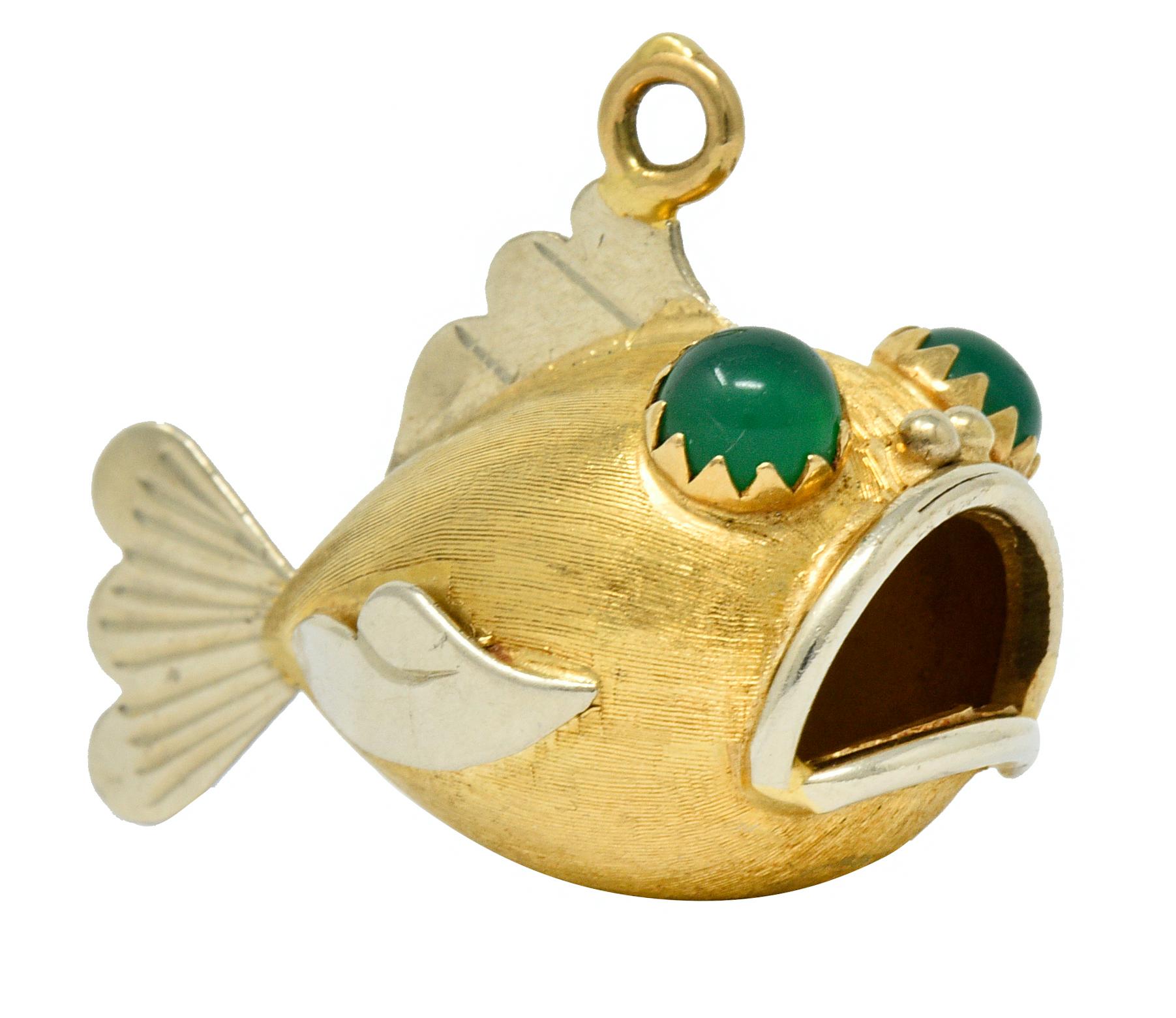 Fish charm is designed with an open mouth revealing the open cavity of its stomach

With cartoonish white gold features and a strongly brushed yellow gold body

Featuring 5.0 mm round glass cabochon eyes; bright translucent green in color

Tested as