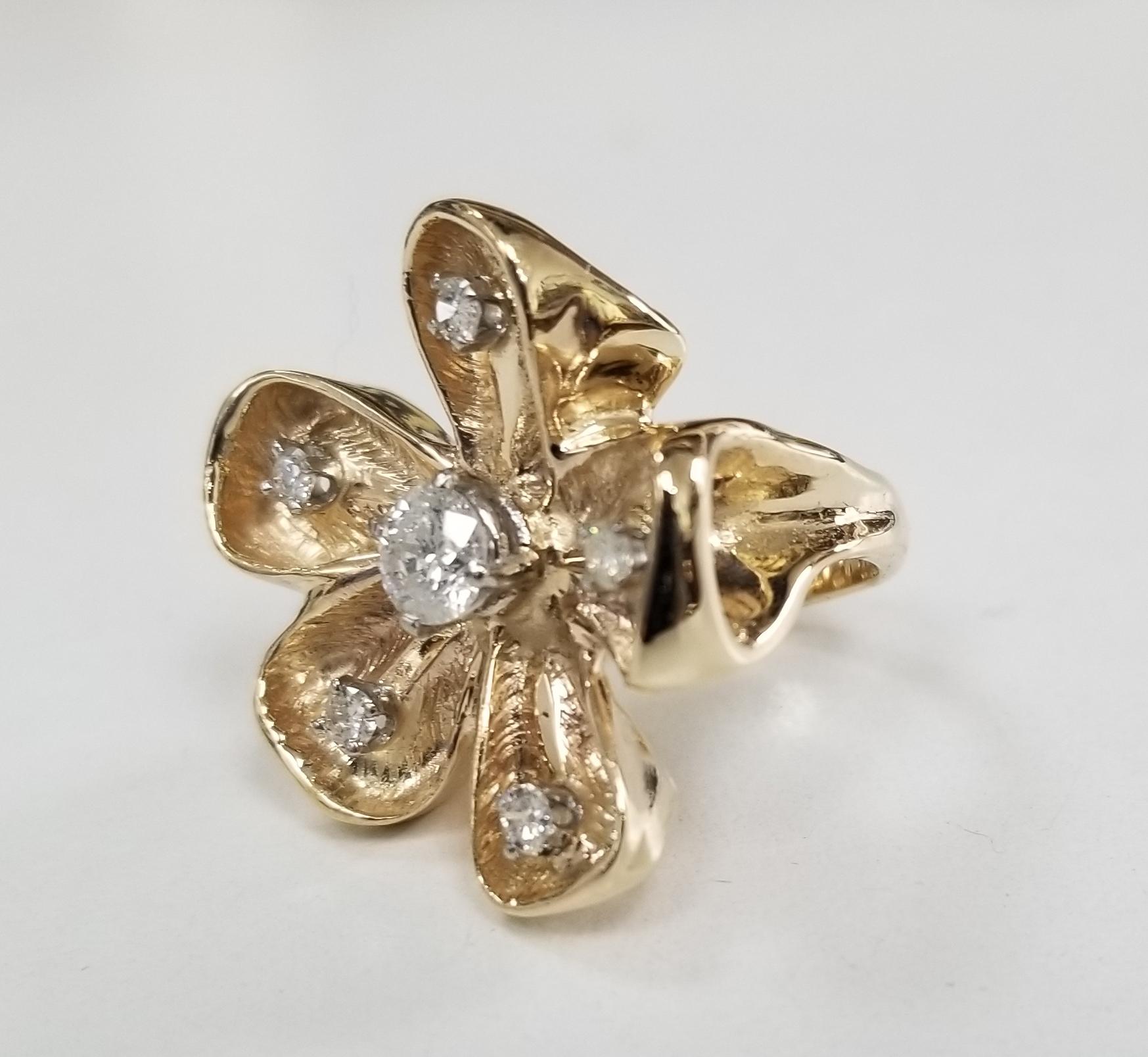1960's Vintage 14k yellow gold diamond flower ring, containing 1 brilliant cut diamond weighing .41pts. and full cut diamonds of fine quality weighing .20pts.  the ring is a size 3 and can be size to fit for free.