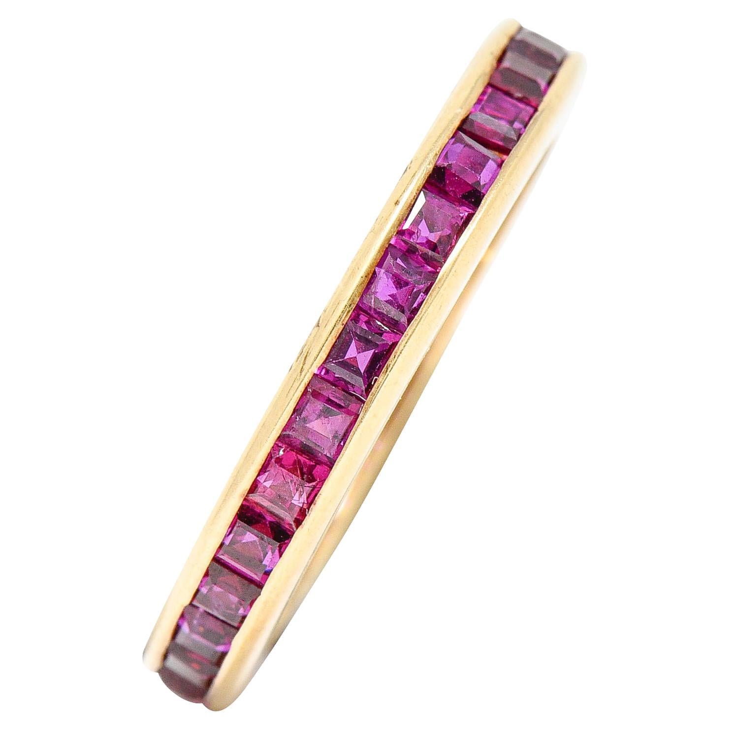 Eternity band ring is channel set fully around with square cut rubies

Very well matched purplish red color while weighing in total approximately 2.00 carats

Completed by polished gold channel walls

Tested as 14 karat gold

Circa: 1960s

Ring