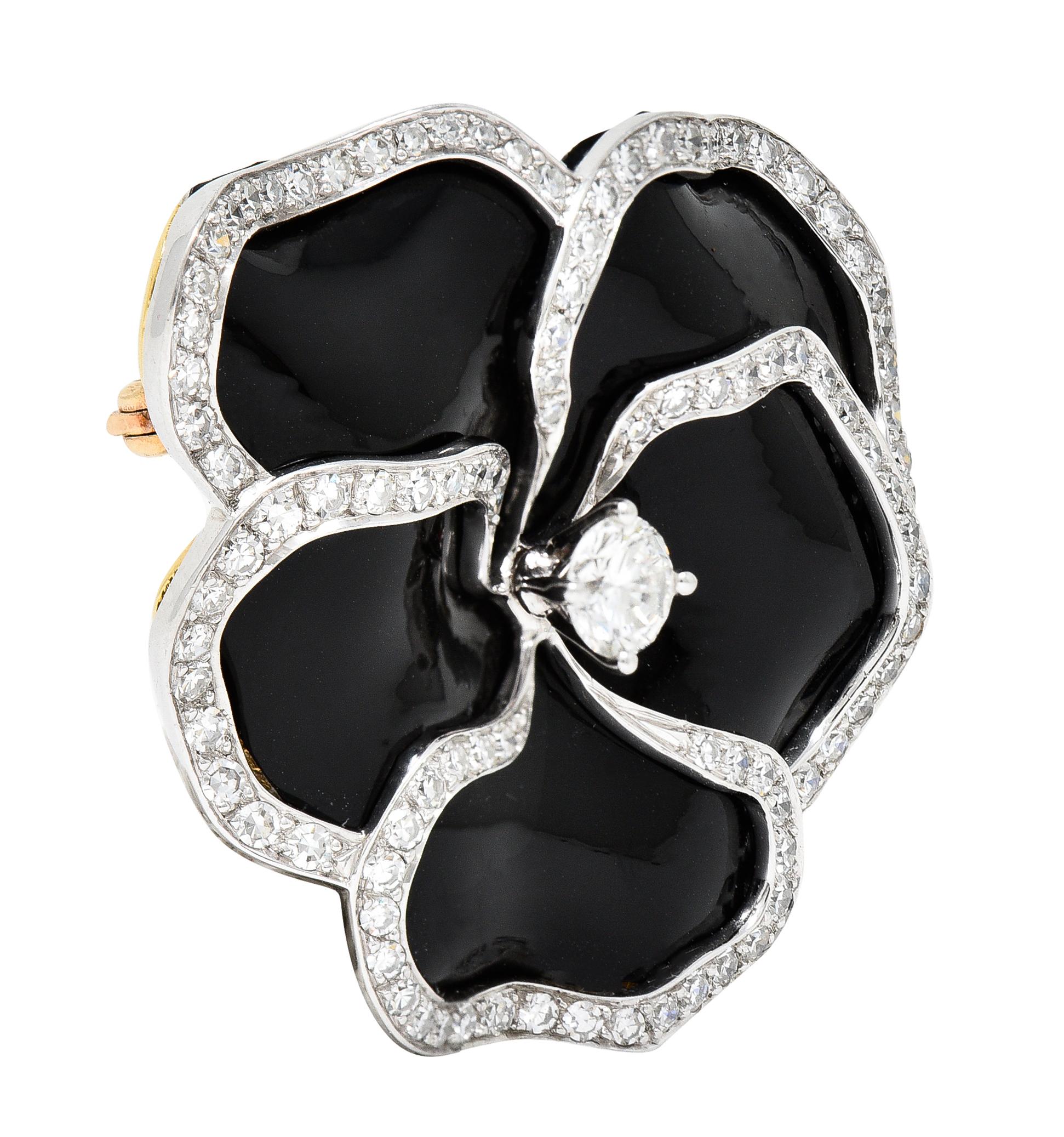 Brooch is designed as a stylized pansy flower with a platinum diamond frame riveted over glossy black vinyl fabric and backed by 18 karat yellow gold. Can be disassembled via screw mechanism at back to change fabric material. Centers a round