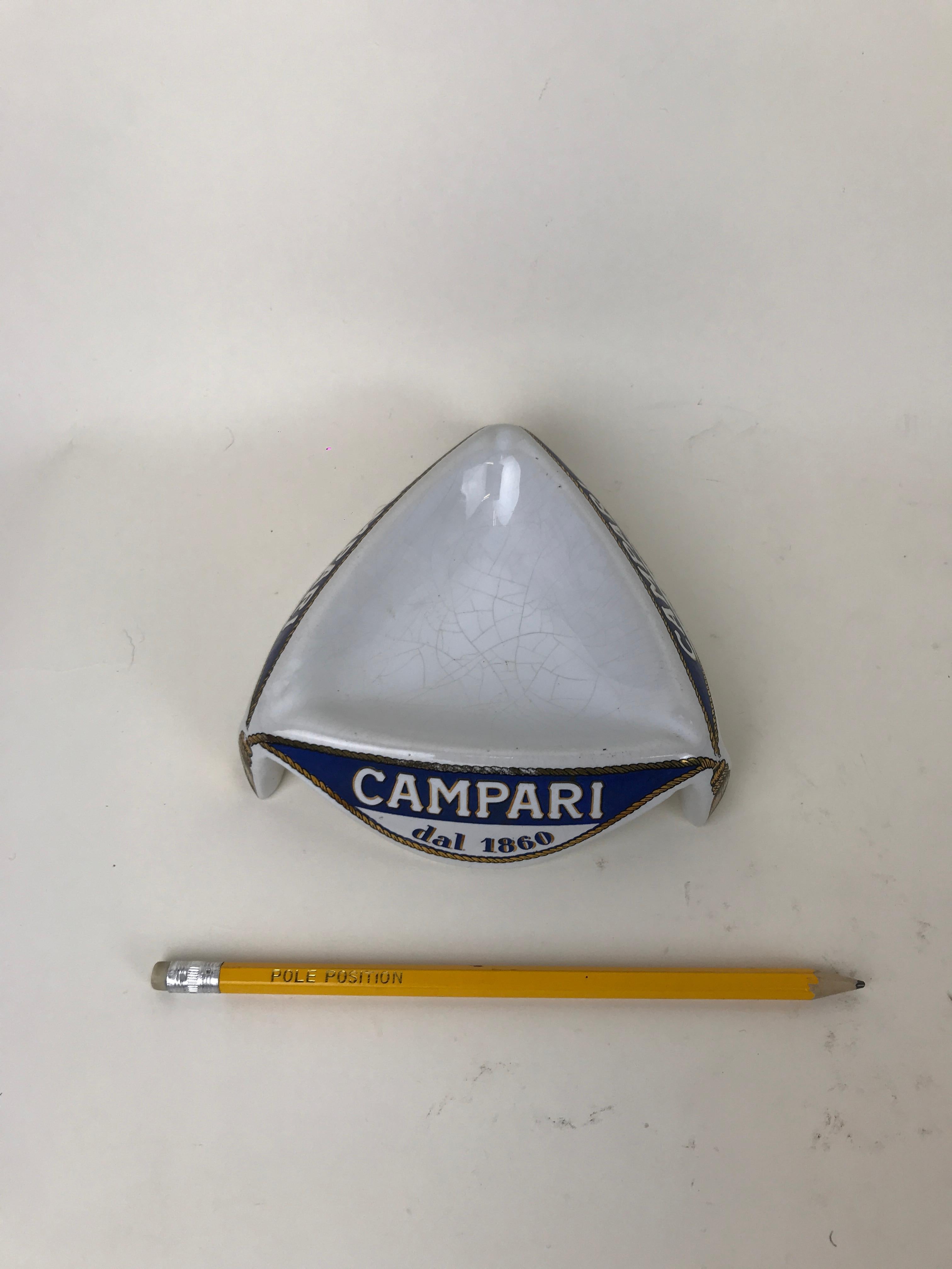 Vintage Campari advertising ashtray in ceramic made in Italy by Ceramica E Piola in Carpignano Sesia, Novara in the 1960s.

The ashtray is decorated with three 
