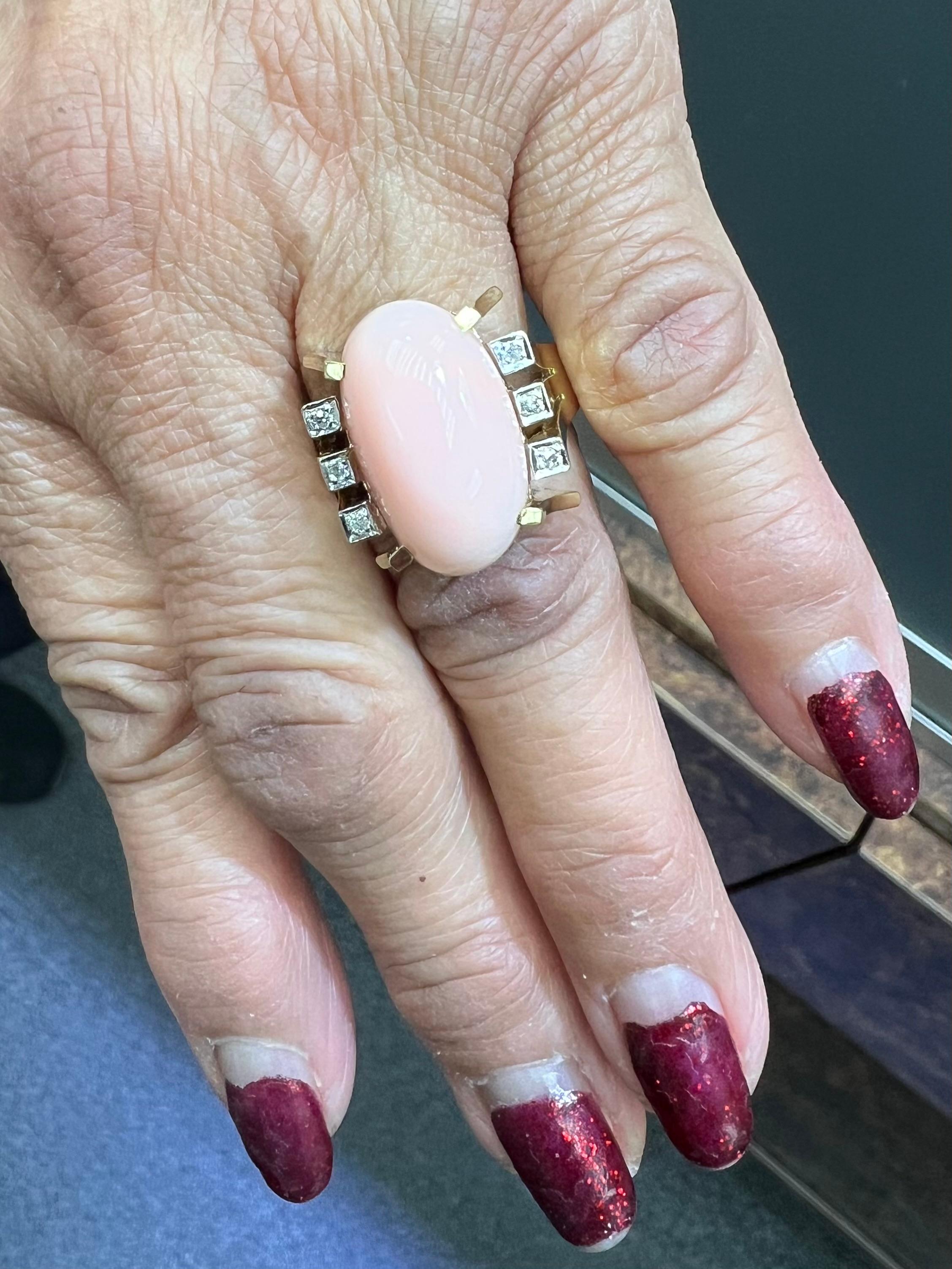 1960s Vintage Angel Skin Coral and Diamond 14k yellow gold ring.

The 1960s Vintage Angel Skin Coral and Diamond 14K Yellow Gold Ring exemplifies the distinctive artistry and craftsmanship characteristic of jewelry from that era. This particular