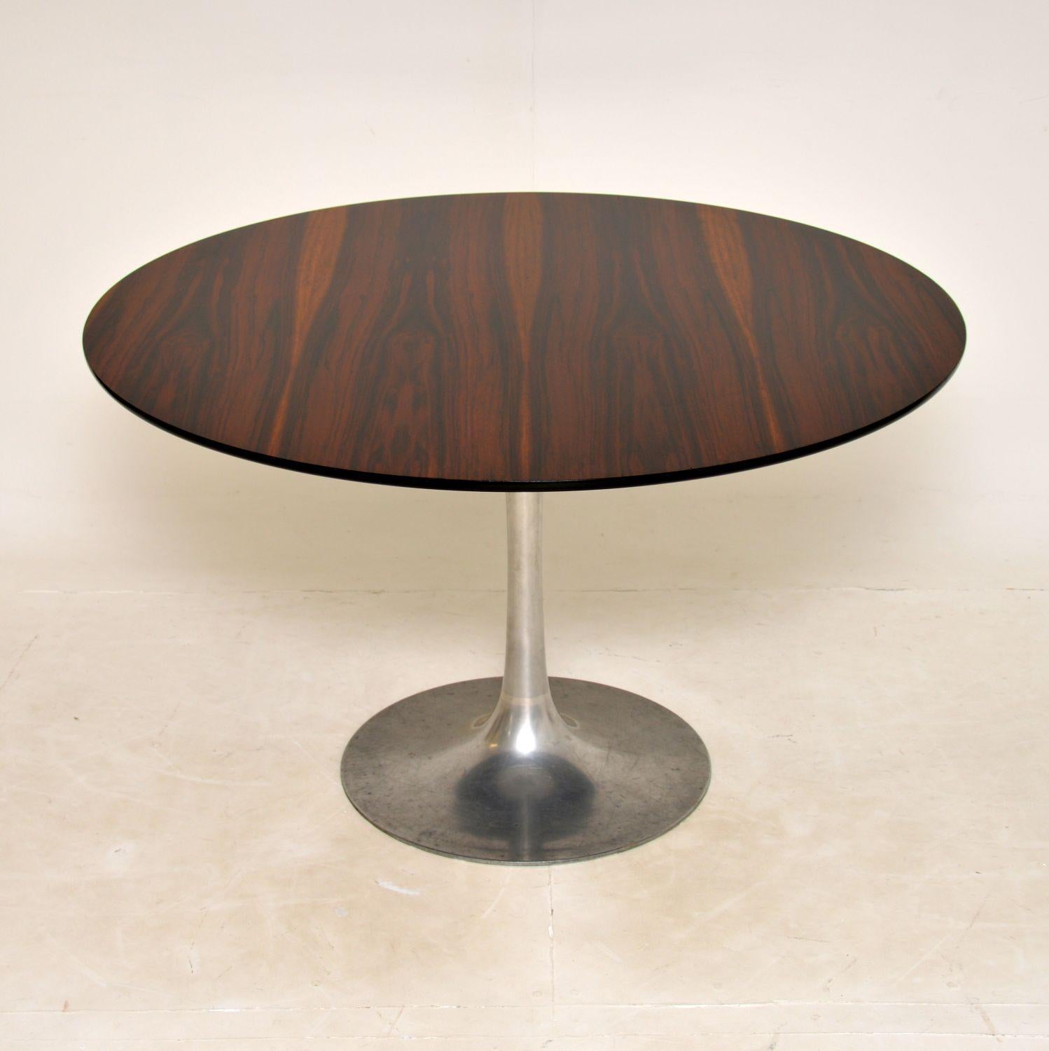 A stunning and very rare vintage circular tulip dining table, designed by Maurice Burke for Arkana. This was made in England, it dates from the 1960’s.

This rare version has a stunning circular wood top, and a brushed steel weighted tulip