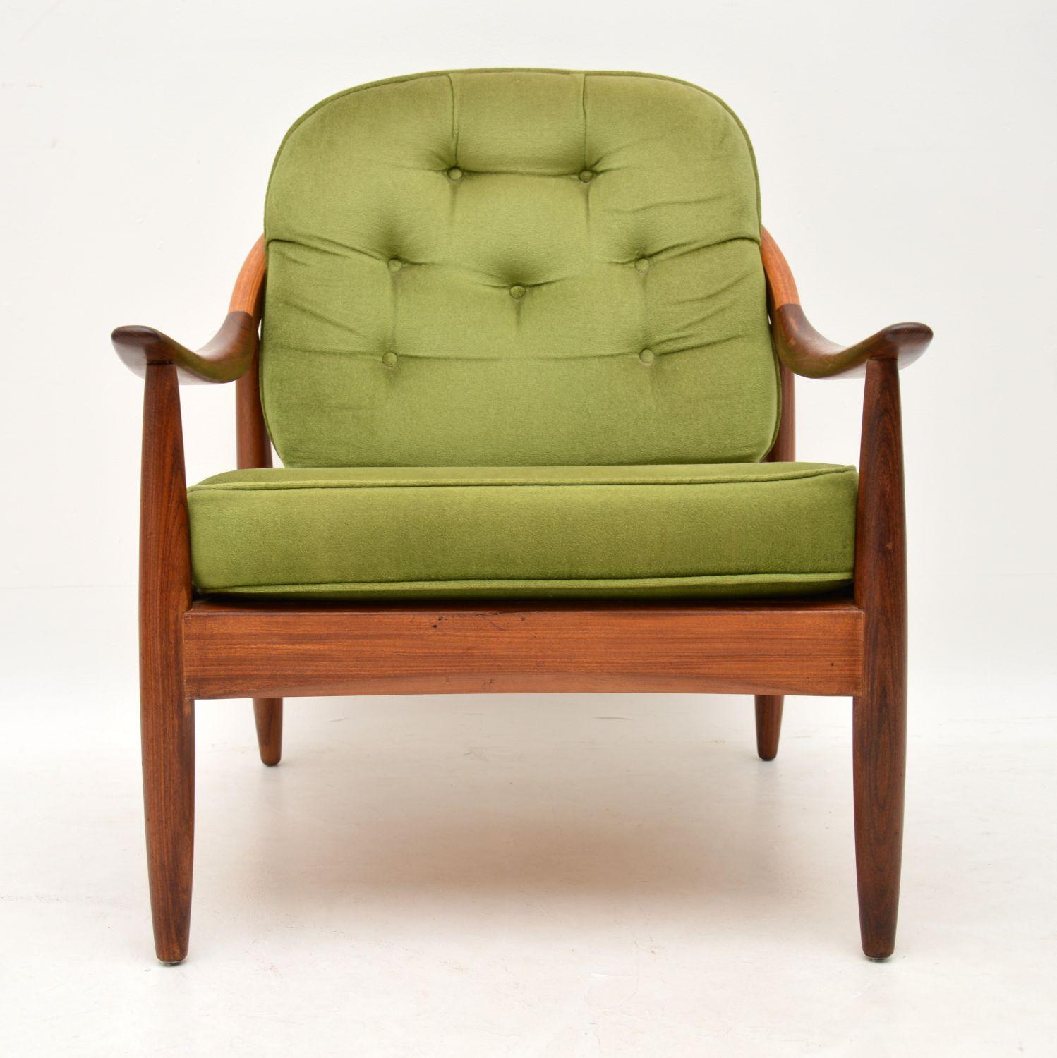 A beautiful vintage armchair in solid afromosia, this was made by Greaves & Thomas, it dates from the 1960s. The condition is great for its age, the frame is very clean, sturdy and sound, we have given it a clean and fresh coat of oil. At some stage