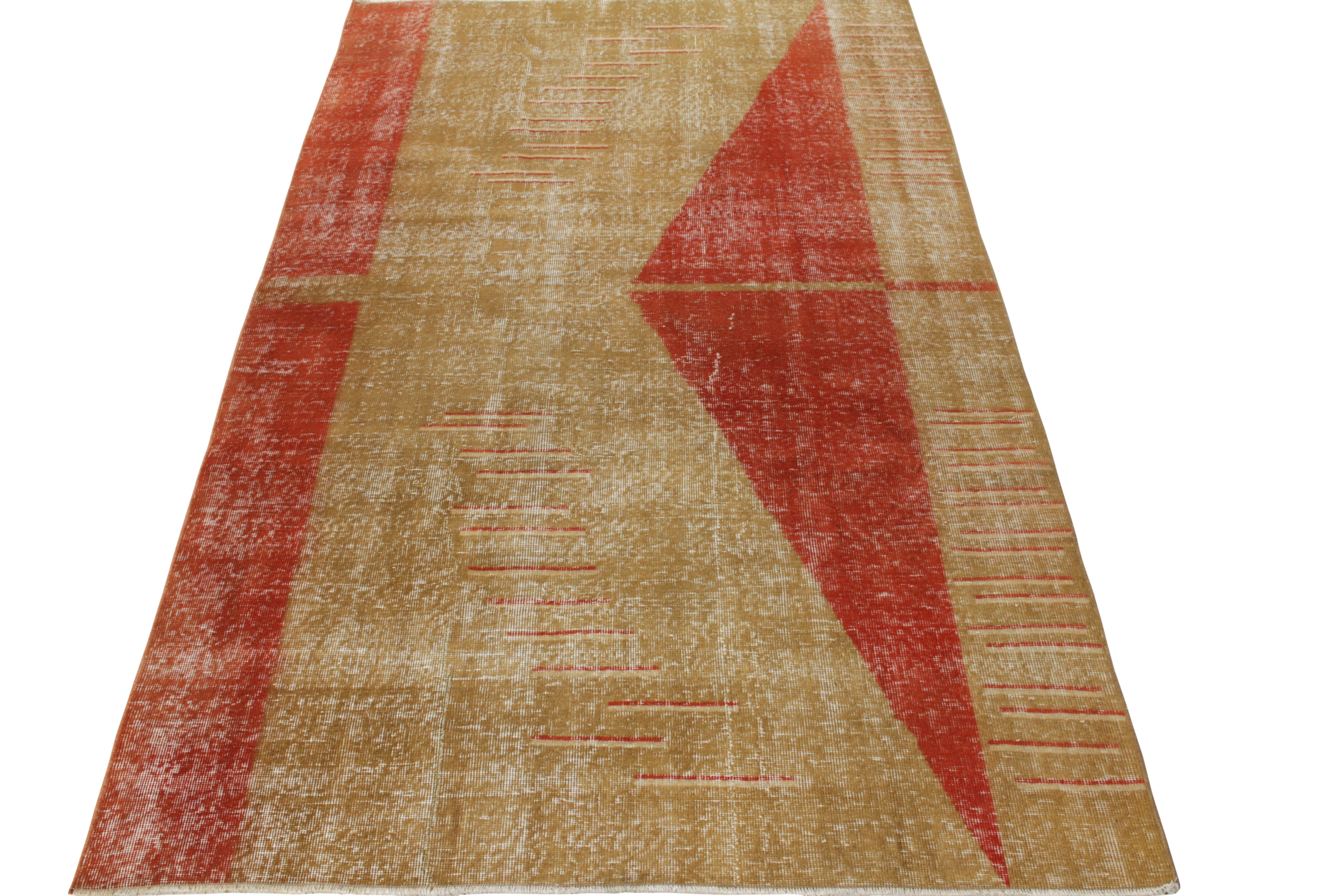 A specimen of artisanal conviction, this 5x8 vintage distressed rug emanates the exclusivity of the Turkish style in the 1960s. Employing fine quality wool, this phenomenal drawing from a renowned Turkish designer witnesses a distinctive geometric