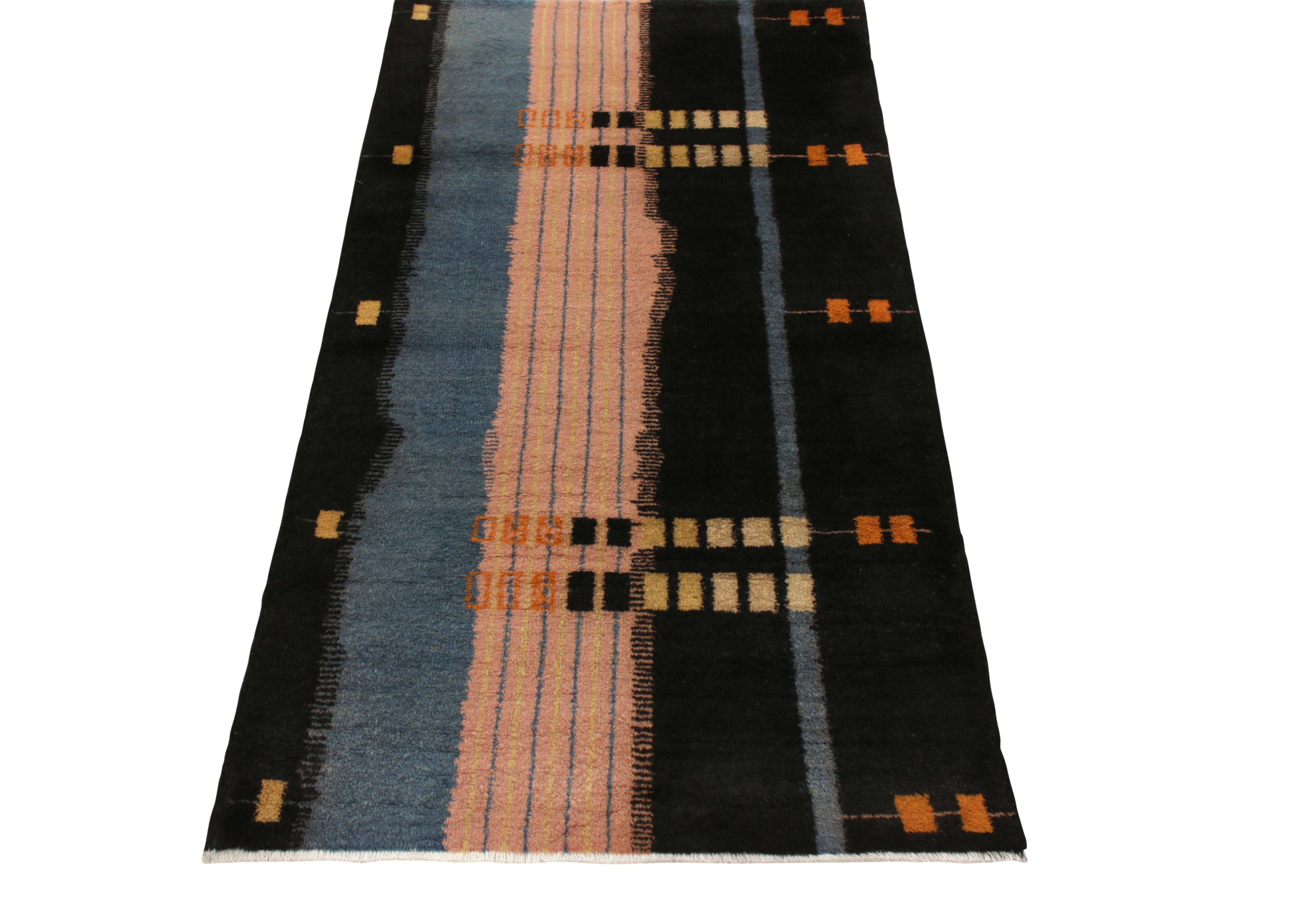 Celebrating a rare mid-century style of the 1960s, Rug & Kilim presents this 3x5 Turkish vintage Art Deco rug crafted by Zeki Müren from its commemorative Mid-Century Pasha Collection. Hand-knotted in wool, this piece features solid black and blue