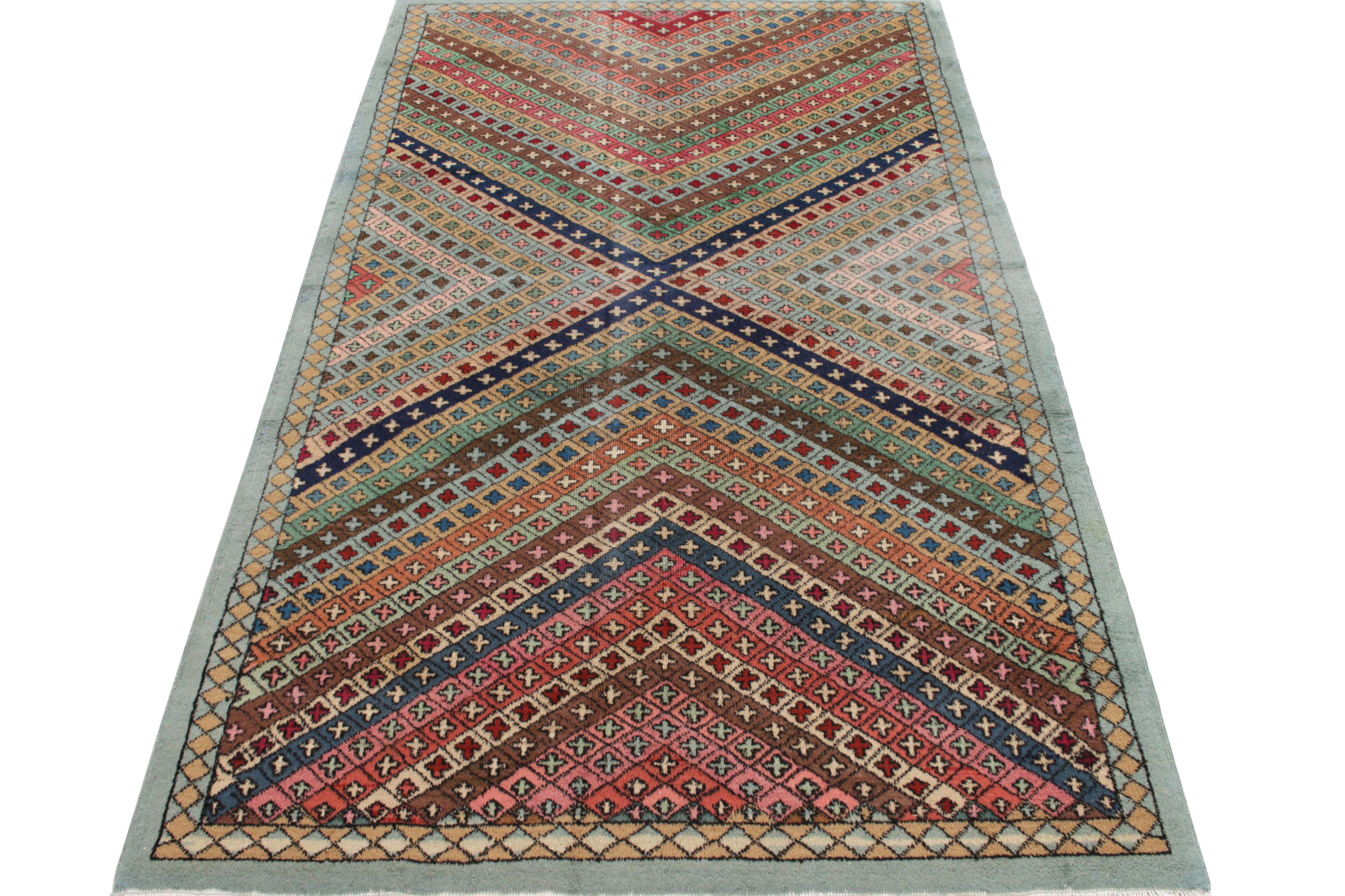 Hand-knotted in wool, a 5x9 vintage rug from a venerated multidisciplinary Turkish designer commemorated in Rug & Kilim’s Mid-Century Pasha Collection. The visually arresting geometry witnesses a spectacle of whimsical tones of carrot red, blue,