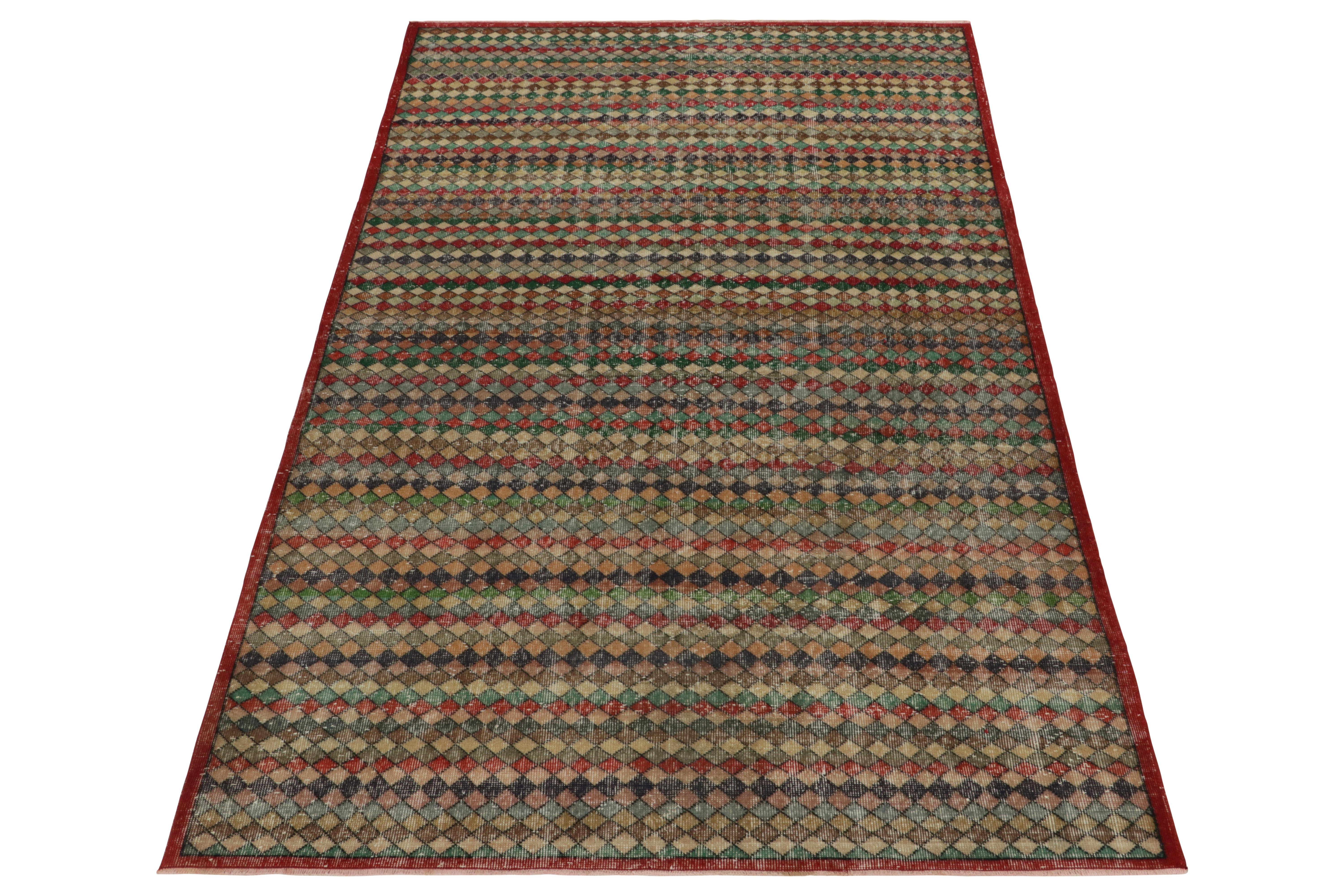 Hand-knotted in wool originating from Turkey circa 1960-1970, this vintage mid-century 6x10 Deco rug belongs to Rug & Kilim’s expansive Mid-Century Pasha collection that celebrates a bold Turkish designer from this period. Carrying a distressed,