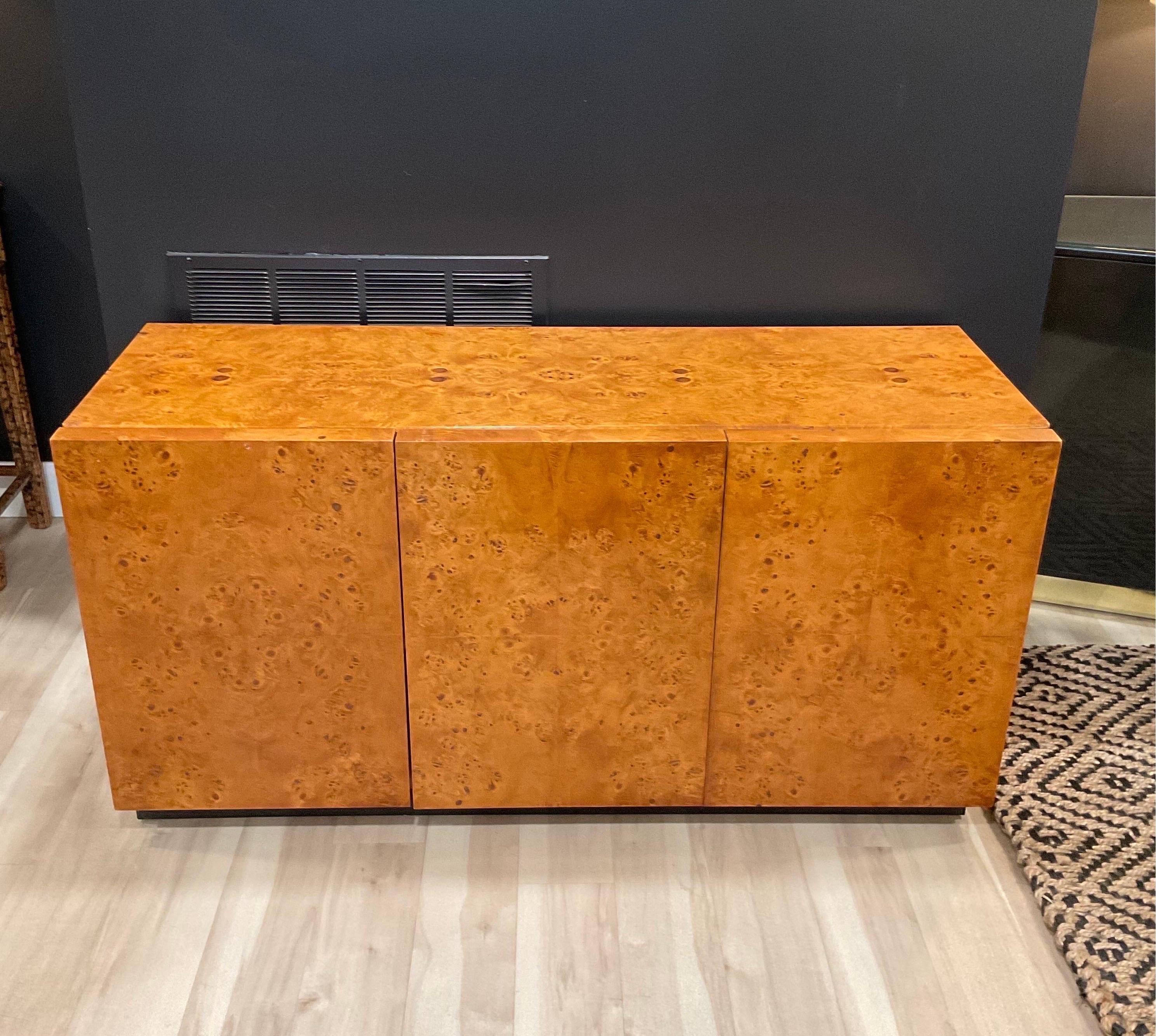 Just a gorgeous piece. This unmarked Arthur Umanoff burled beauty is a stunner. Minimal marks/flaws in the original vintage finish but there are a few and part of the character of the piece. Functions as intended with doors closing properly and