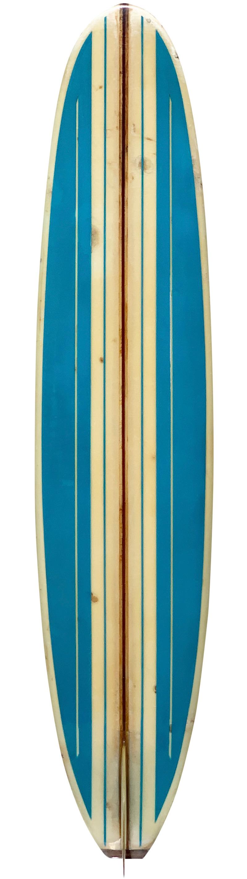 Mid-1960s Bing classic longboard. Features beautiful blue panels with pinstriping, redwood and balsa t-band stringer, and gorgeous wooden fin. A remarkable example of an all original 1960s longboard made under the iconic Bing Surfboards label.