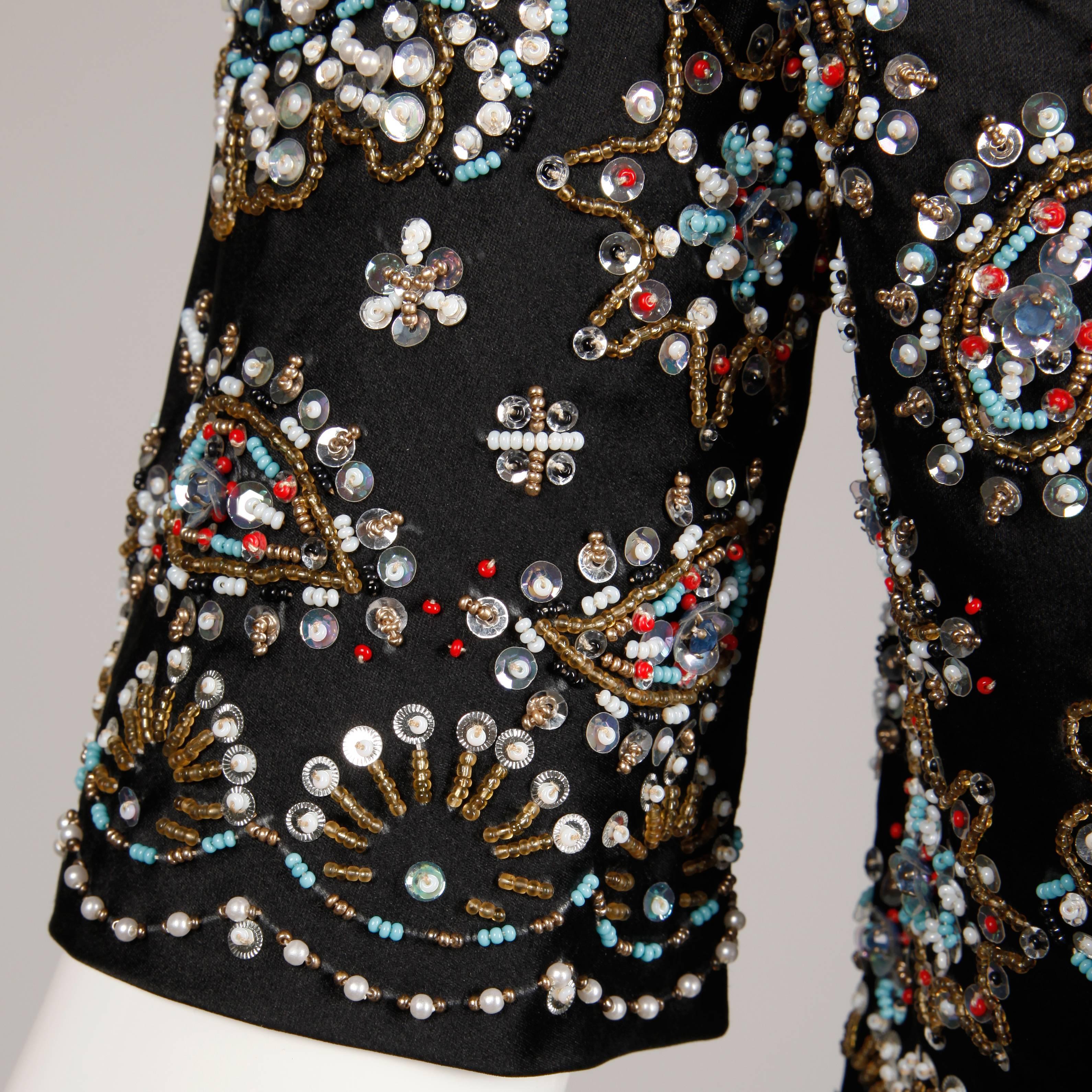 Gorgeous black silk satin bolero jacket with metallic multicolor beadwork and sequin embellishment. Fully lined with front hook closure. Silk satin outer with rayon lining. The marked size is 8, but the jacket fits like a modern size small. The bust
