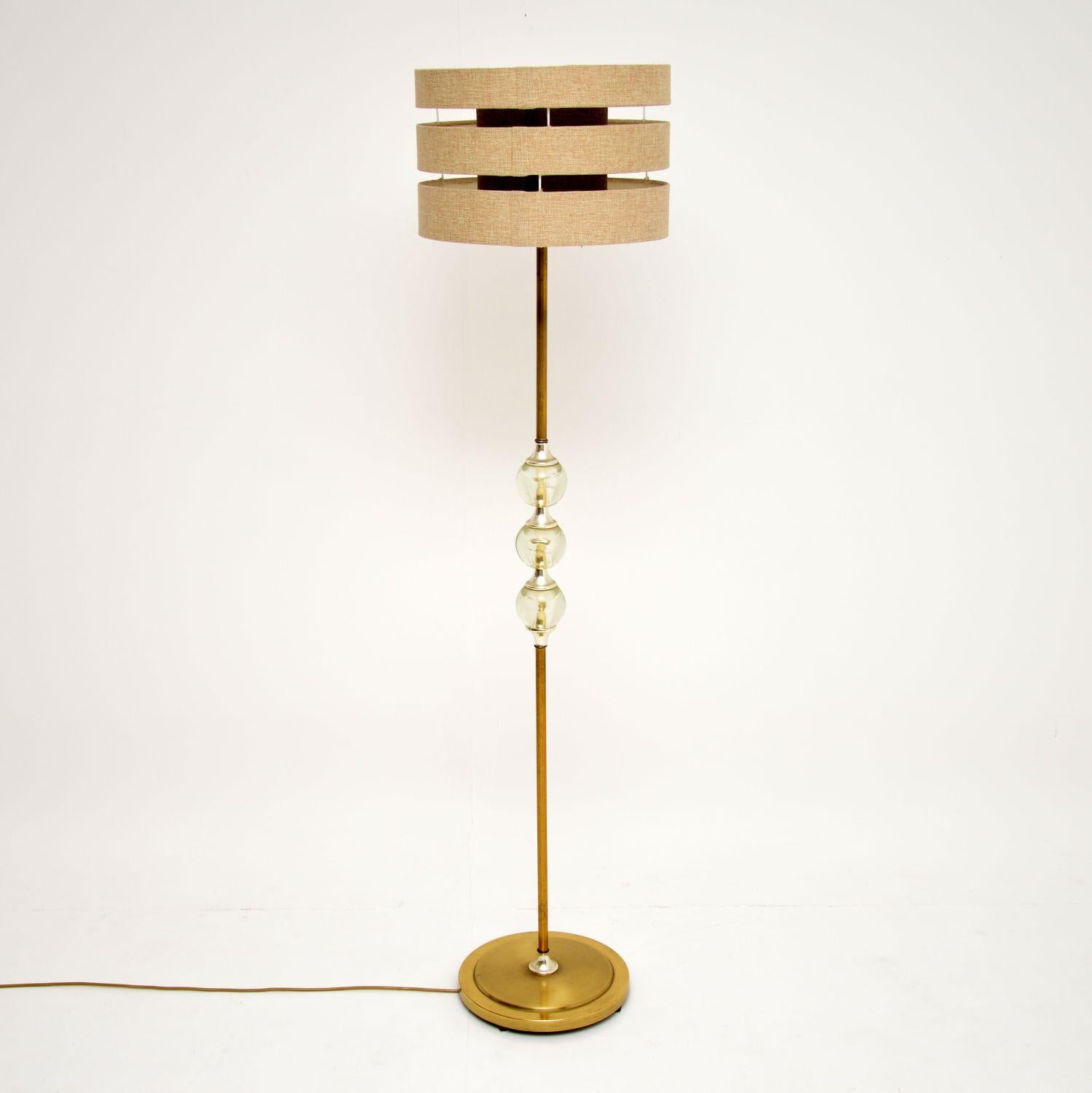 A stylish and very unusual vintage floor lamp, dating from the 1960s. This has a brass stand with three interesting balls in the middle made from acrylic. This is in good vintage condition and in good working order, there is just some minor wear