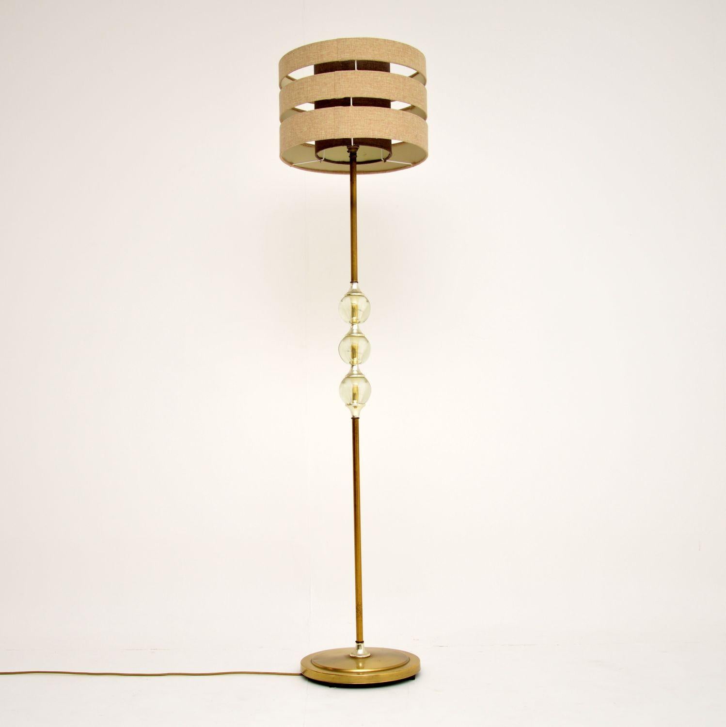 A stylish and very unusual vintage floor lamp, dating from the 1960’s. This has a brass stand with three interesting balls in the middle made from acrylic. This is in good vintage condition and in good working order, there is just some minor wear