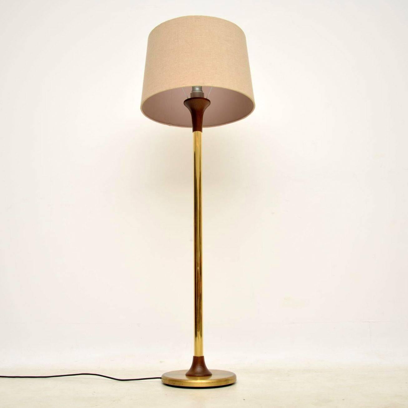 A beautiful vintage floor lamp in brass and solid wenge wood, this dates from the 1960s. It's in very good condition for its age, with just some minor superficial wear to the brass base; the wood is all beautifully grained and in great condition. We