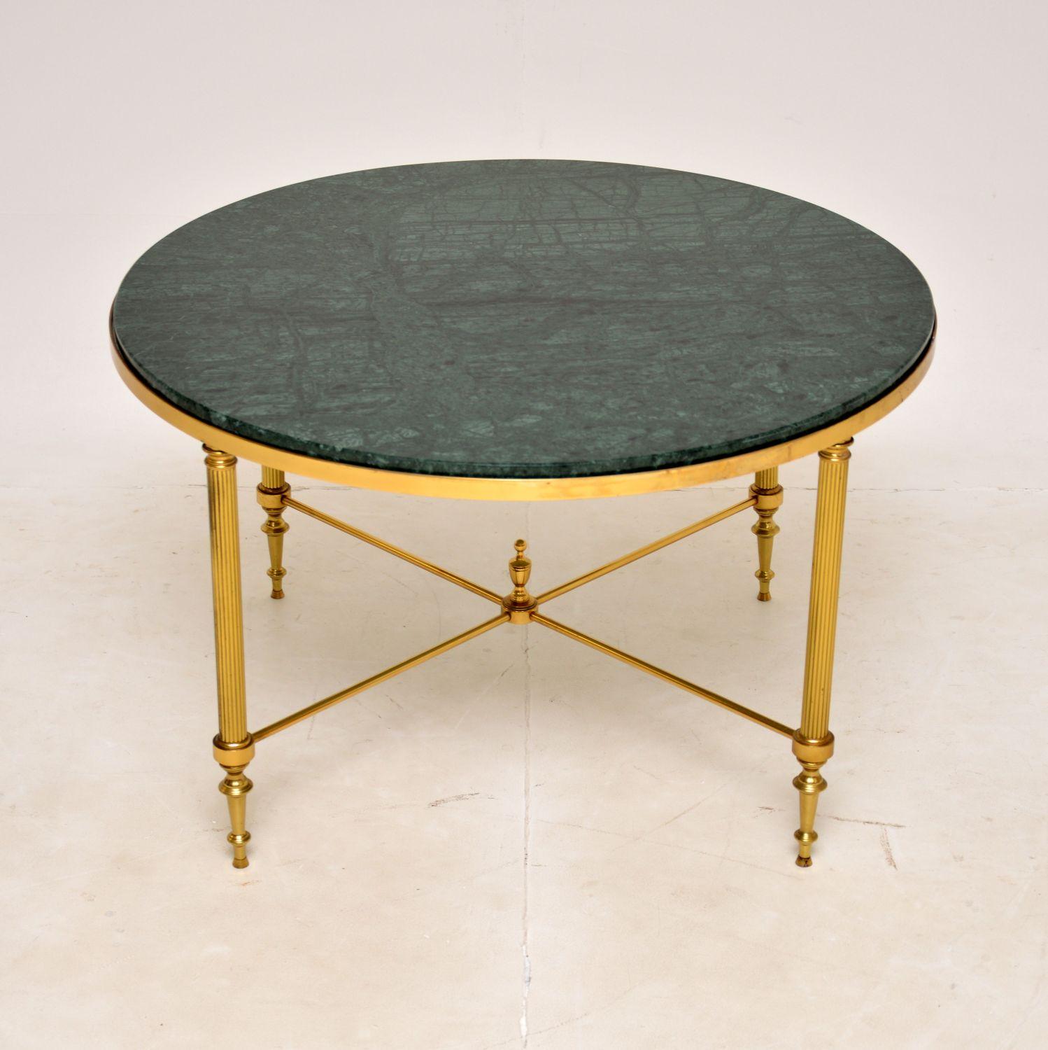A stunning vintage circular coffee table in solid brass and marble. This was made in France, it dates from around the 1960-70’s.

It is of superb quality and has a gorgeous design. The frame is elegant yet sturdy, the inset green marble top