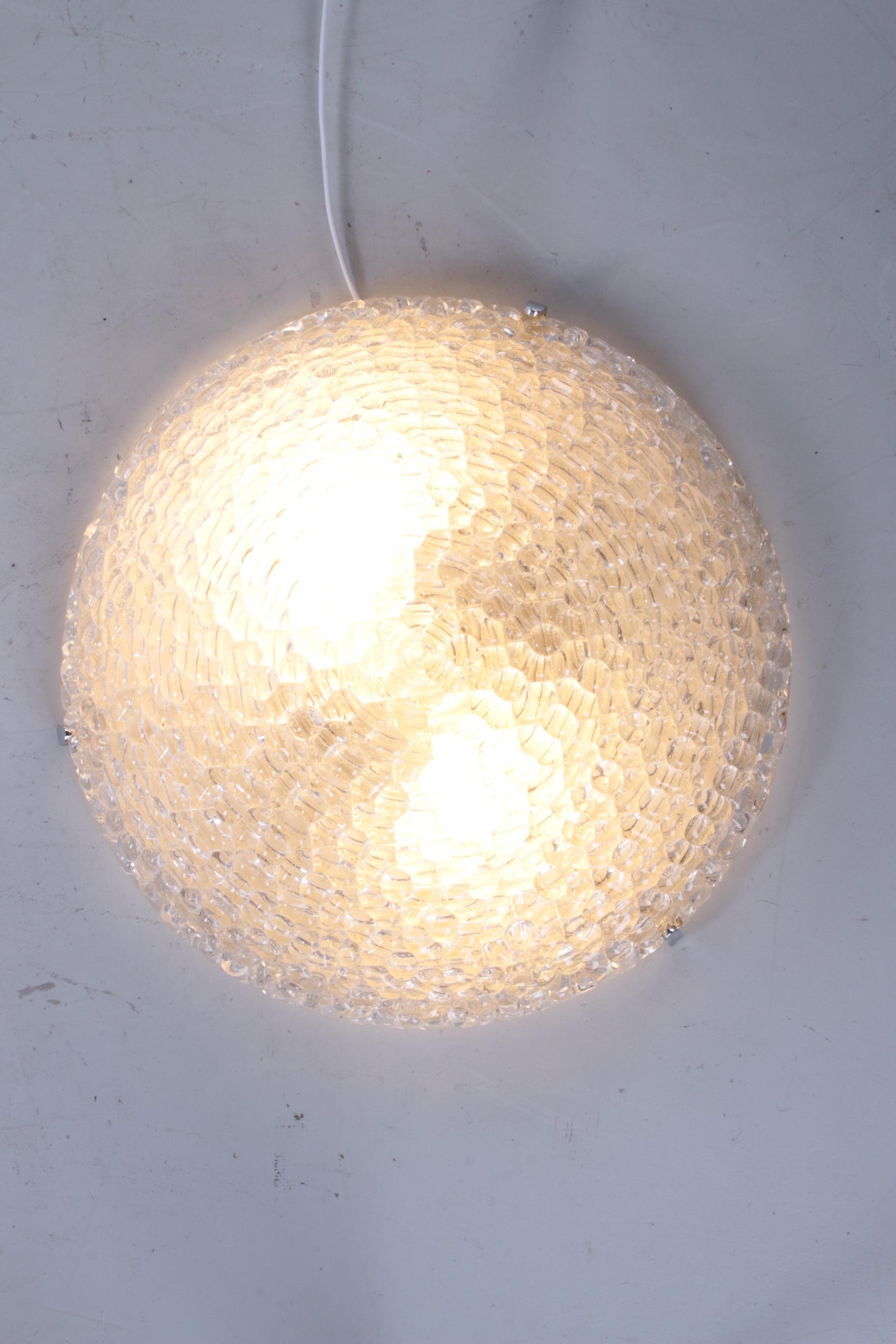 1960s vintage bubble glass ceiling lamp with chrome

The fixture is made of chrome and has a large lampshade, made of thick-walled so-called 