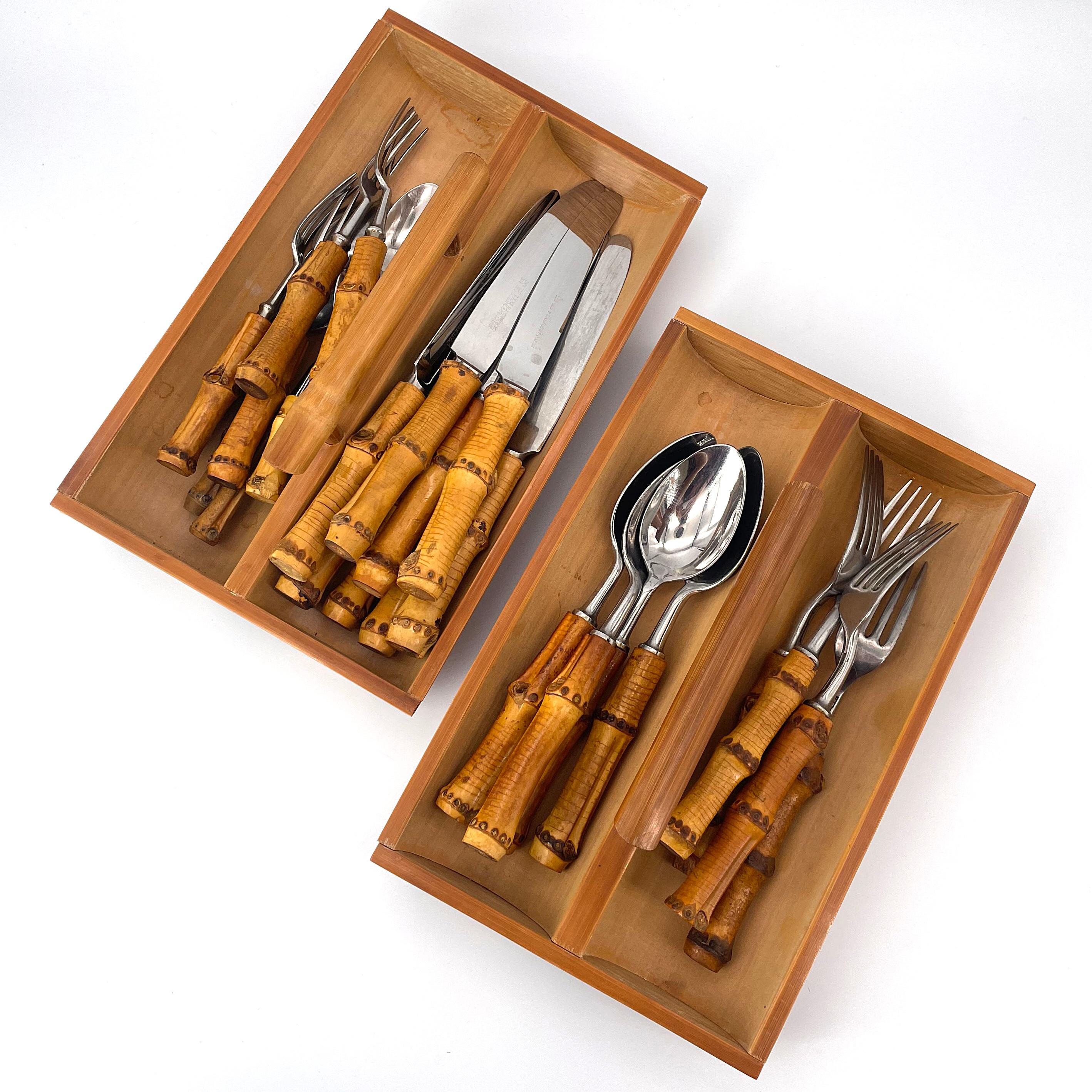 JAPAN, circa 1960s. Made in the Seki, Gifu Prefecture of Japan by Hamono Matsuri. Bamboo handled stainless steel flatware set for 4, in bamboo trays. 25 utensils, and 2 trays included.

(1) Xsm spoon L 4 in.
(4) Sm spoons L 5.5 in.
(4) Sm Forsk L 6