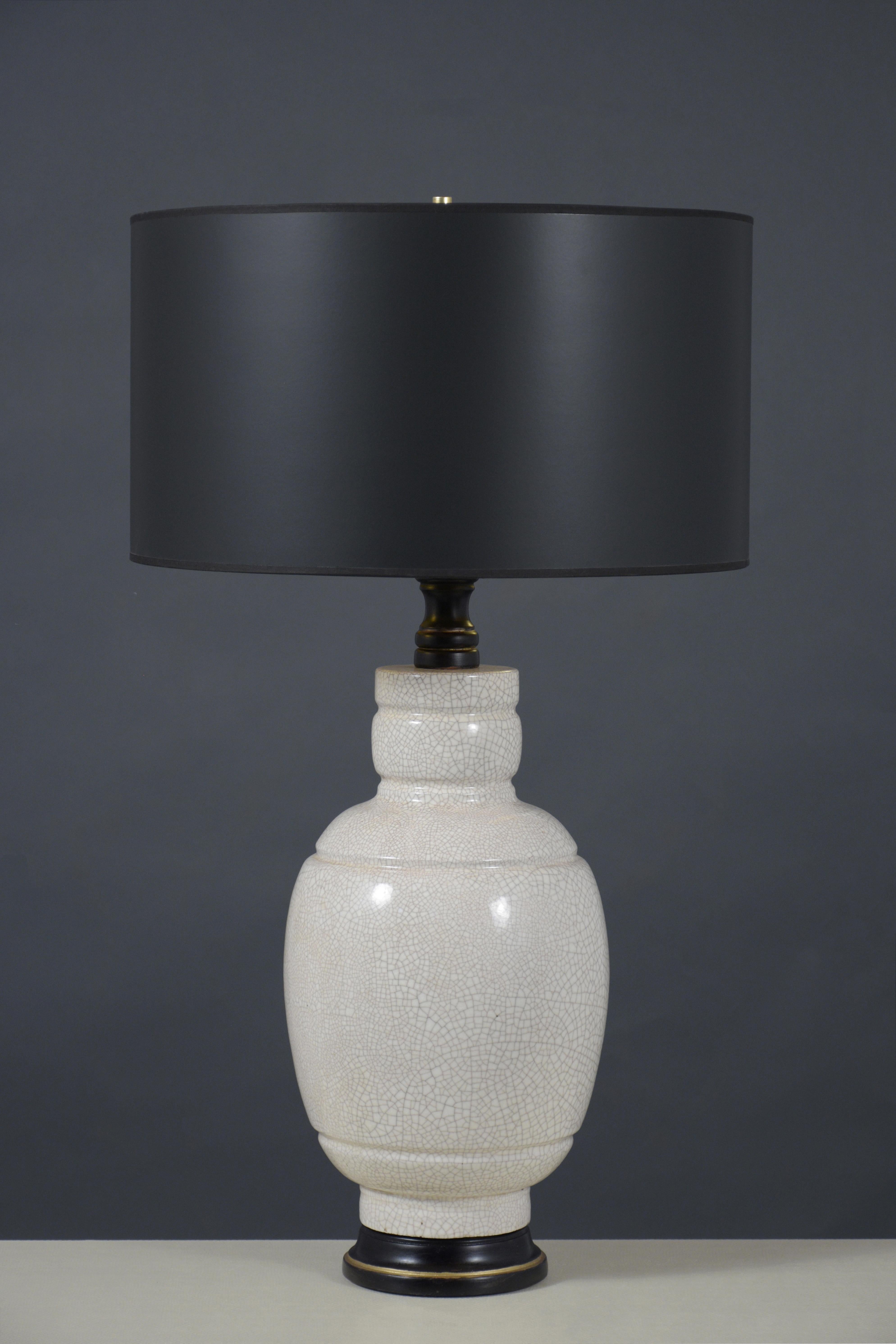 Rediscover the elegance of the 1960s with our pair of ceramic table lamps, each piece expertly restored to blend vintage allure with modern sophistication. Crafted from high-quality ceramics, these lamps feature a unique crackled design that is