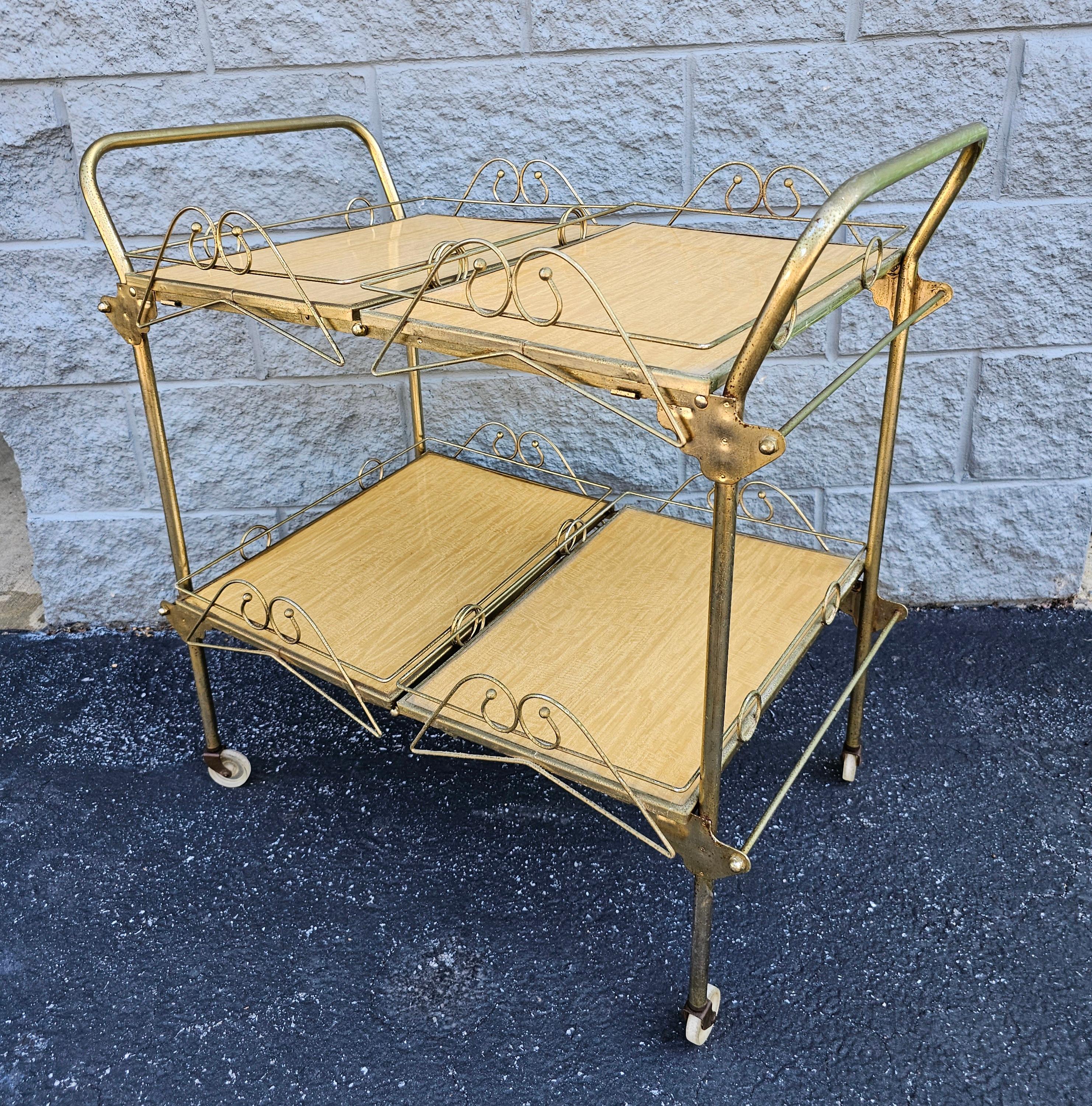 A rare 1960s Vintage Metal Brass Tone  Rolling and Folding 4-Tray Bar attributed to Cesare Lacca. Remove all 4 trays, fold and store while not in use. Measures 30