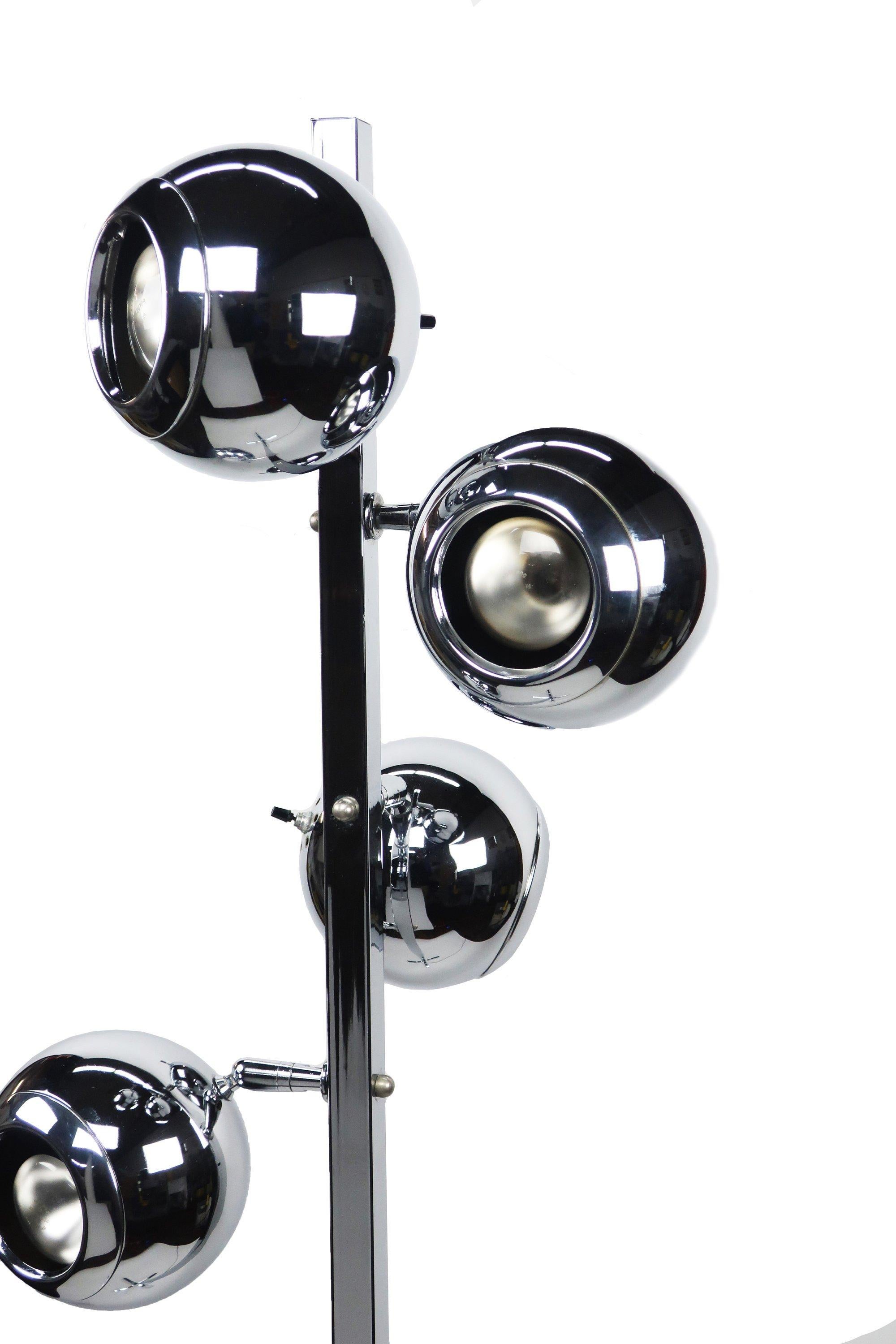 A vintage Mid-Century Modern chrome eyeball floor lamp in the style of Robert Sonneman/George Kovacs or Koch & Lowy, circa 1960s. It features four independently adjustable chrome globe lights on a central chrome stem and base. Each “eyeball” has its