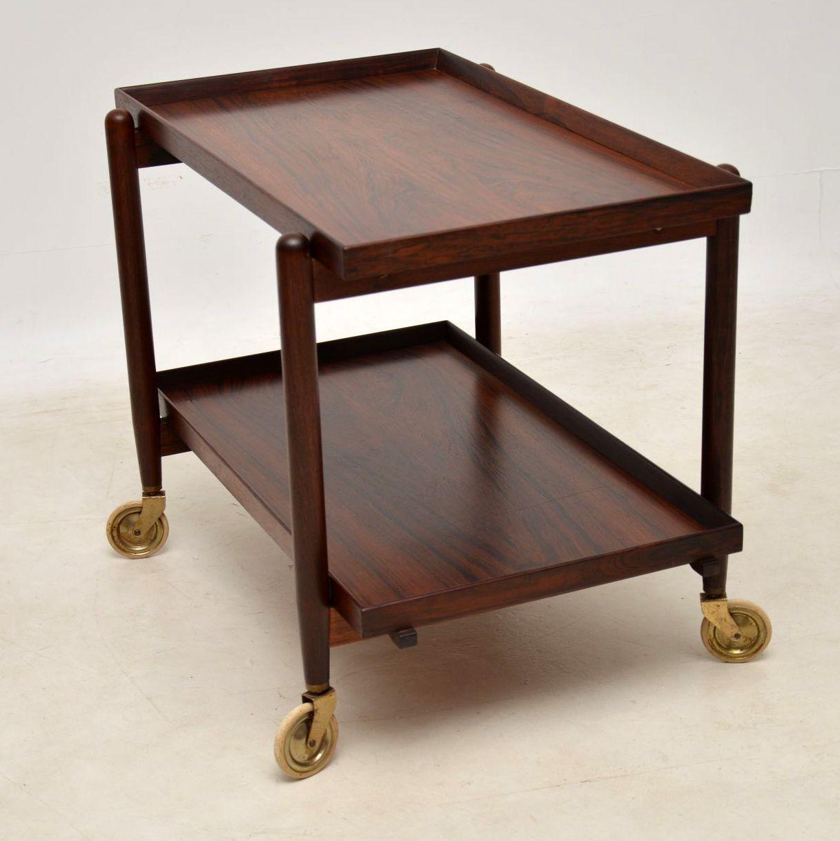 A stunning and extremely well made vintage Danish drinks trolley in rosewood, this was designed by Poul Hundevad, it dates from the 1960s. The top tray slides across, and the bottom tray can then be lifted on to the top surface to effectively double