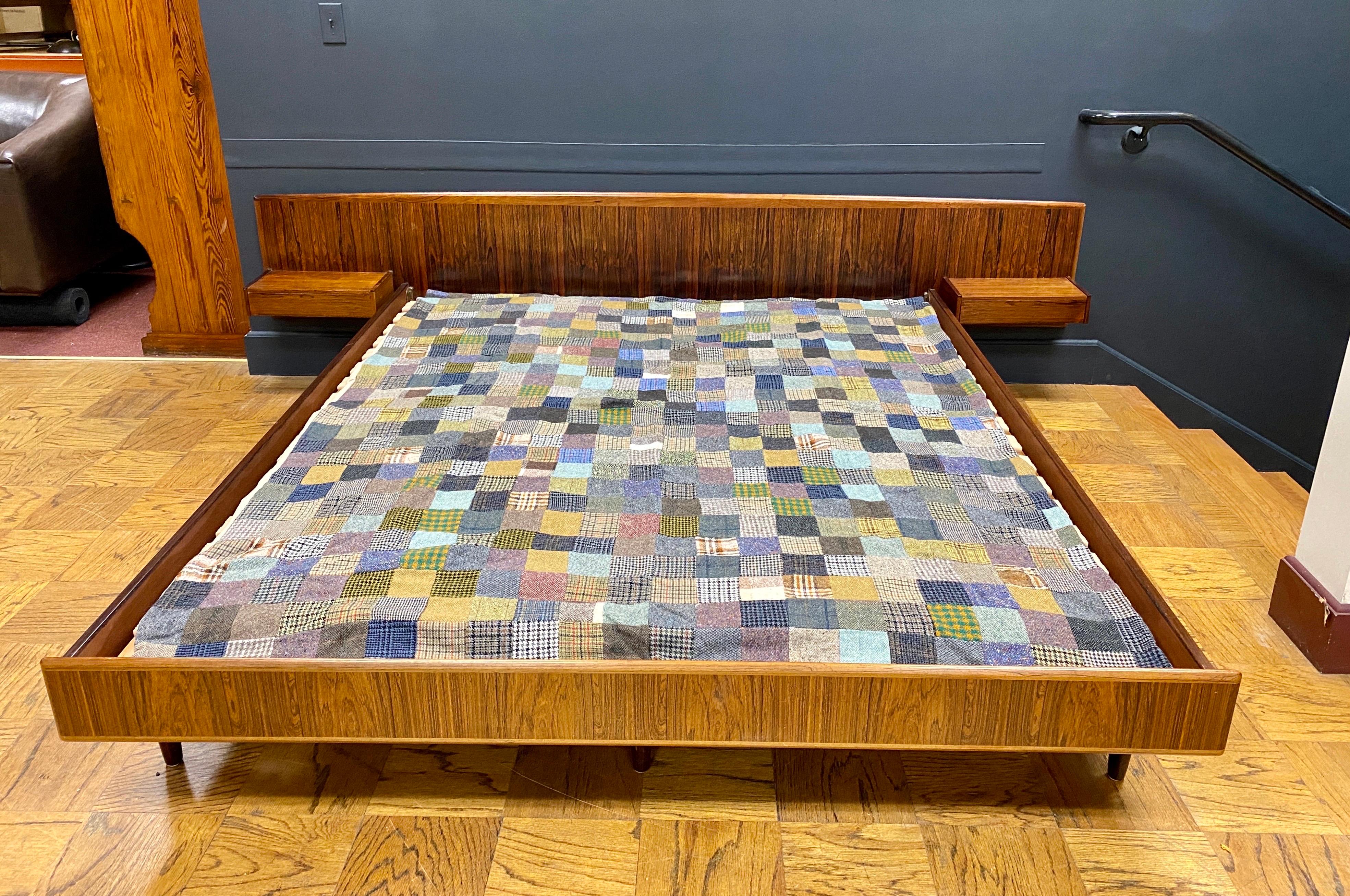 Vintage Danish Rosewood bed with integrated floating single drawer nightstands attached to headboard. 1960s
Headboard measures 104 