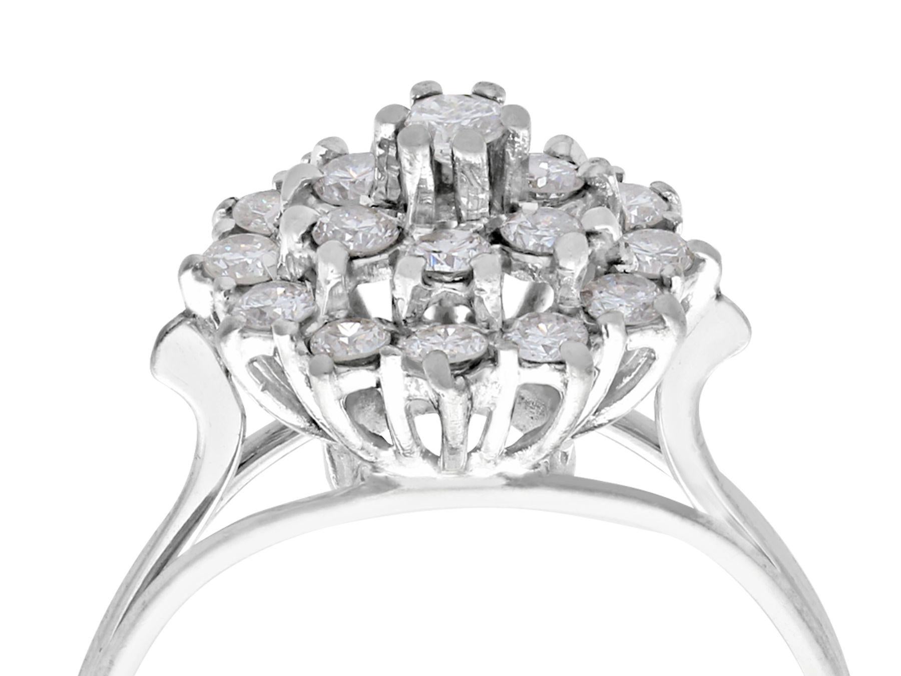 A fine and impressive vintage 0.75 carat and 18 karat white gold cluster ring; part of our vintage jewelry and estate jewelry collections

This fine vintage diamond cluster ring has been crafted in 18k white gold.

The pierced decorated boat style