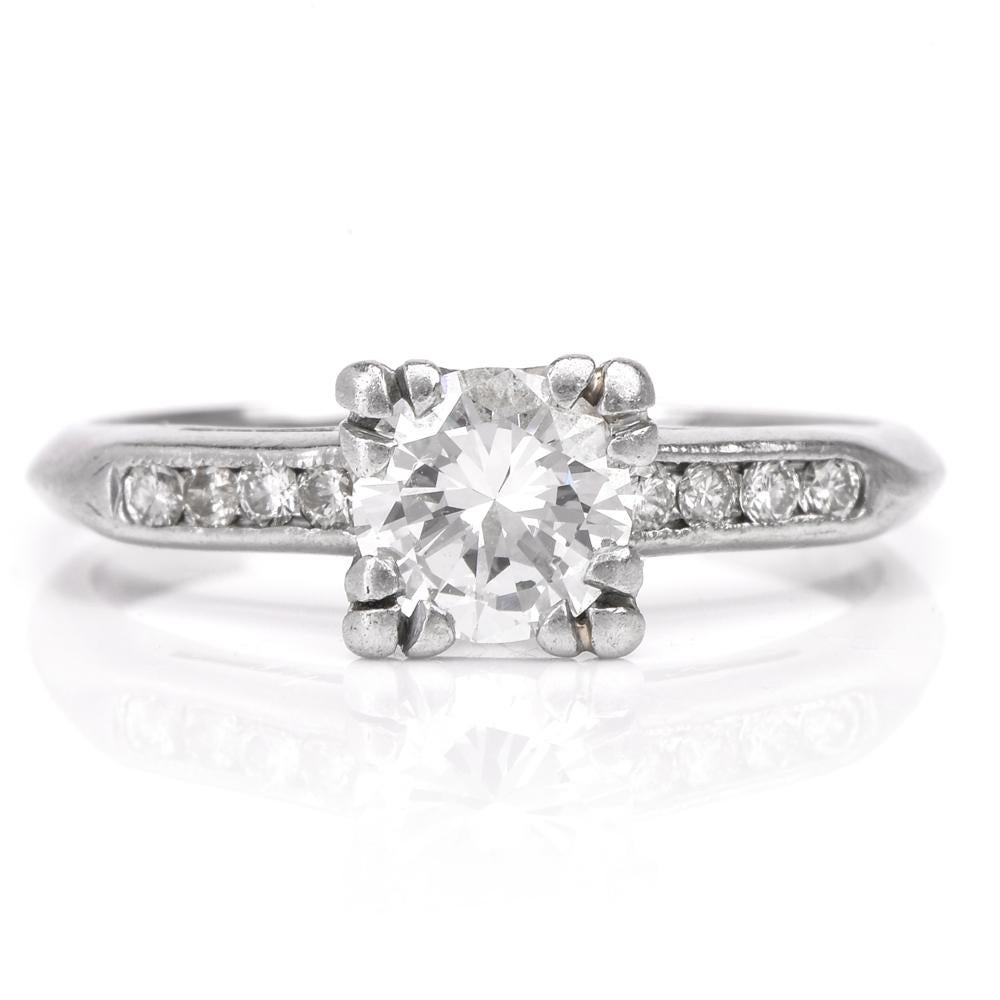 This classic vintage diamond engagement ring is crafted in solid platinum. Showcasing a centered modern brilliant-cut diamond approx. 0.75 carats, graded H-I color, VS1 clarity. Featuring 8 round-cut diamonds at its sides approx. 0.10 carats, graded