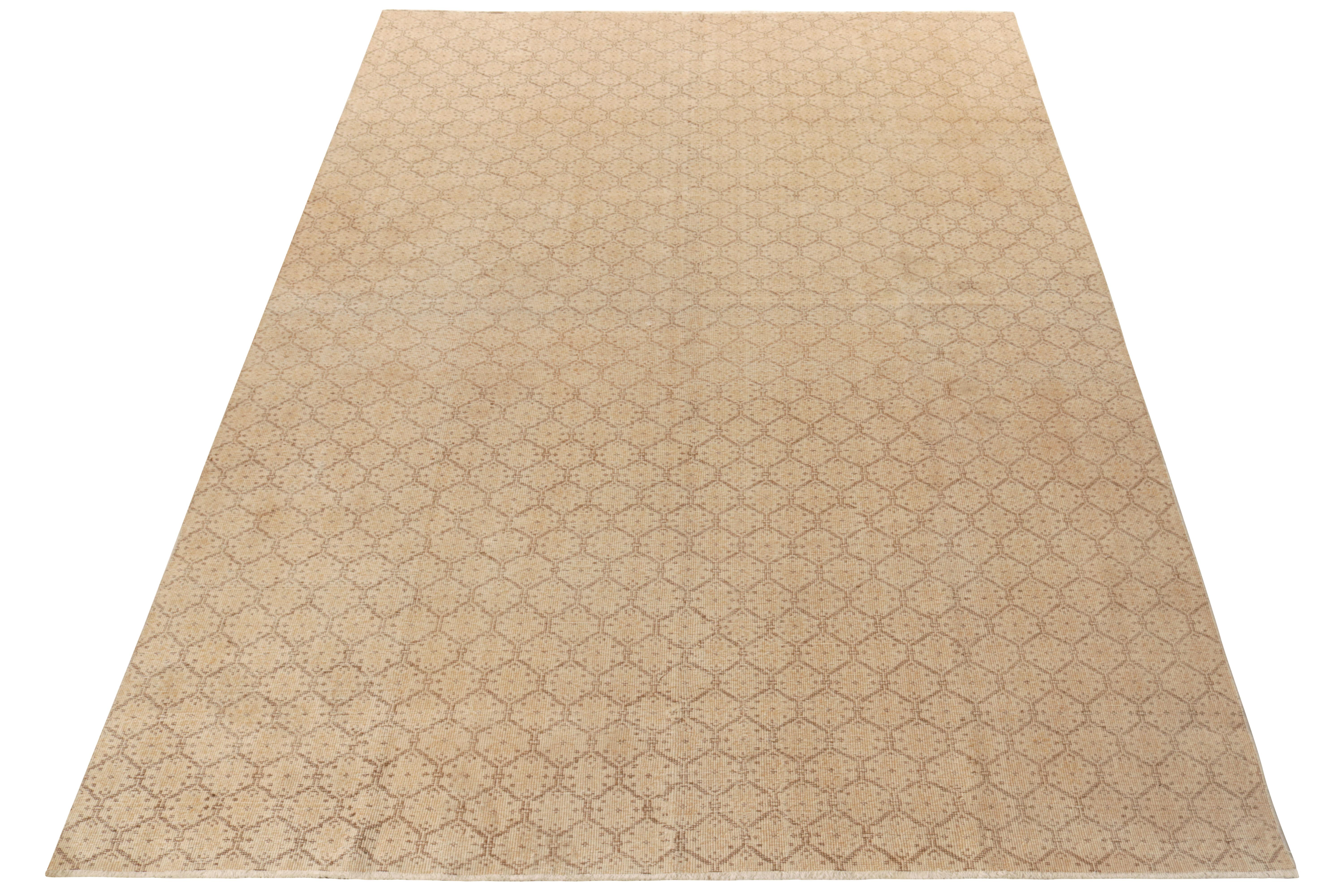 Hand-knotted in wool circa 1960-1970, a 7x11 vintage rug from a bold Turkish designer commemorated in Rug & Kilim’s Mid-Century Pasha Collection. The luxurious piece boasts mid century aesthetics with an engaging trellis honeycomb pattern in beige &