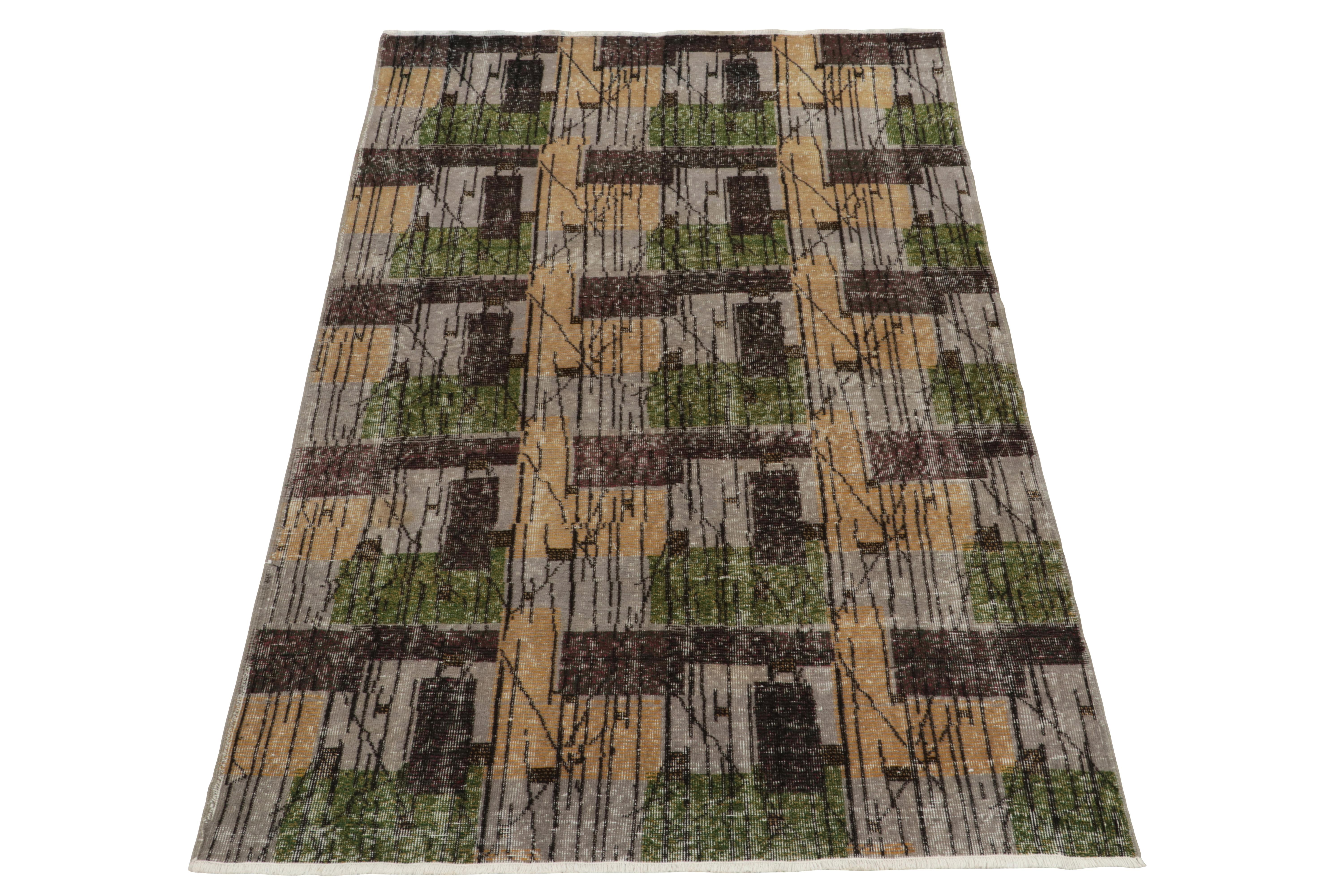 Hand-knotted in wool from Turkey circa 1960-1970, a vintage 5x8 distressed rug from an acclaimed Turkish artist joining Rug & Kilim’s Mid-Century Pasha Collection. The low-pile rug stuns the eye with a well-defined pattern inspired by the union of