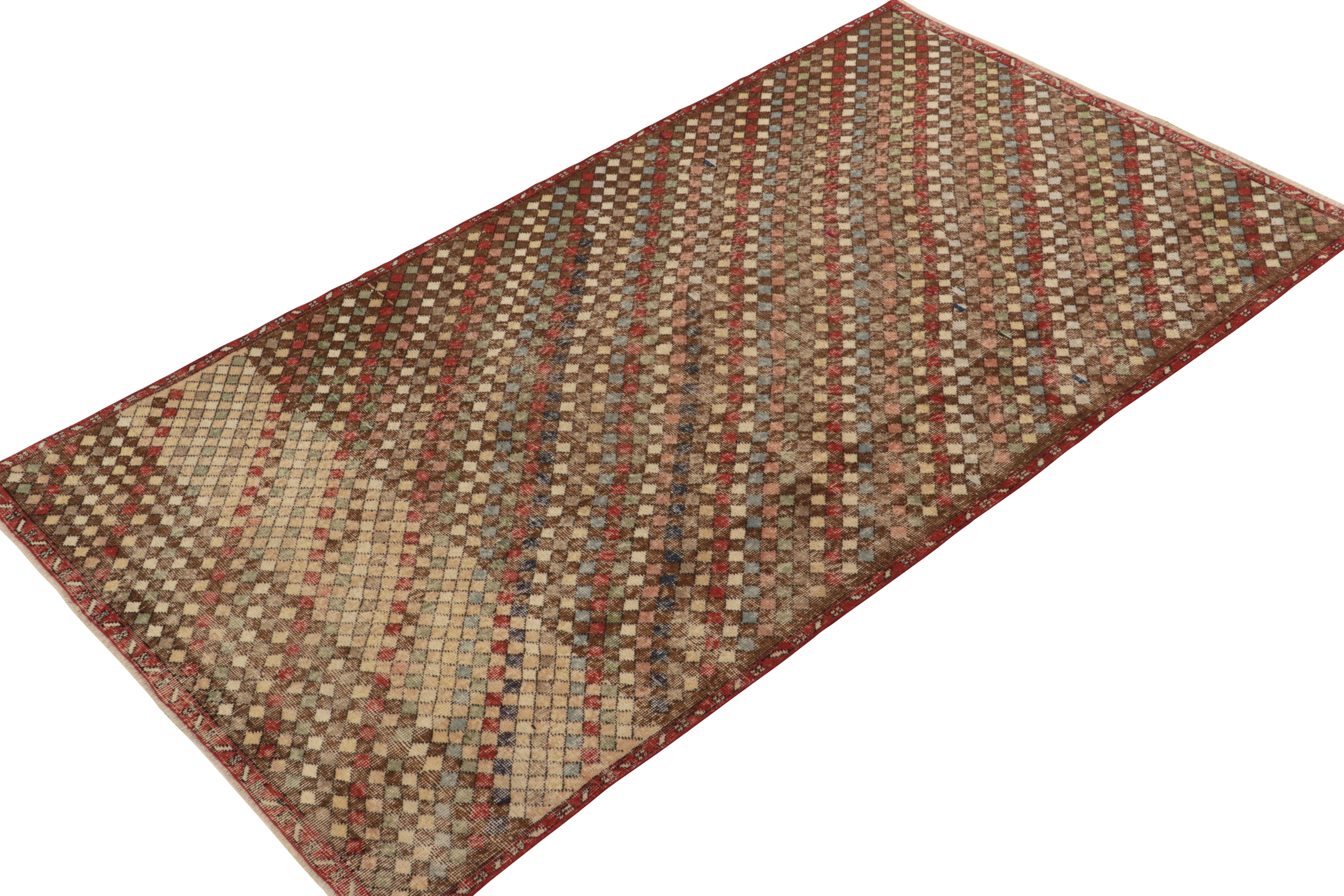 Hand-knotted in wool, a 5x9 vintage rug from a bold Turkish designer, entering Rug & Kilim’s commemorative Mid-Century Pasha Collection. 

This dedicated piece enjoys a dextrous diamond pattern alternating diagonally in variegated tones of red,
