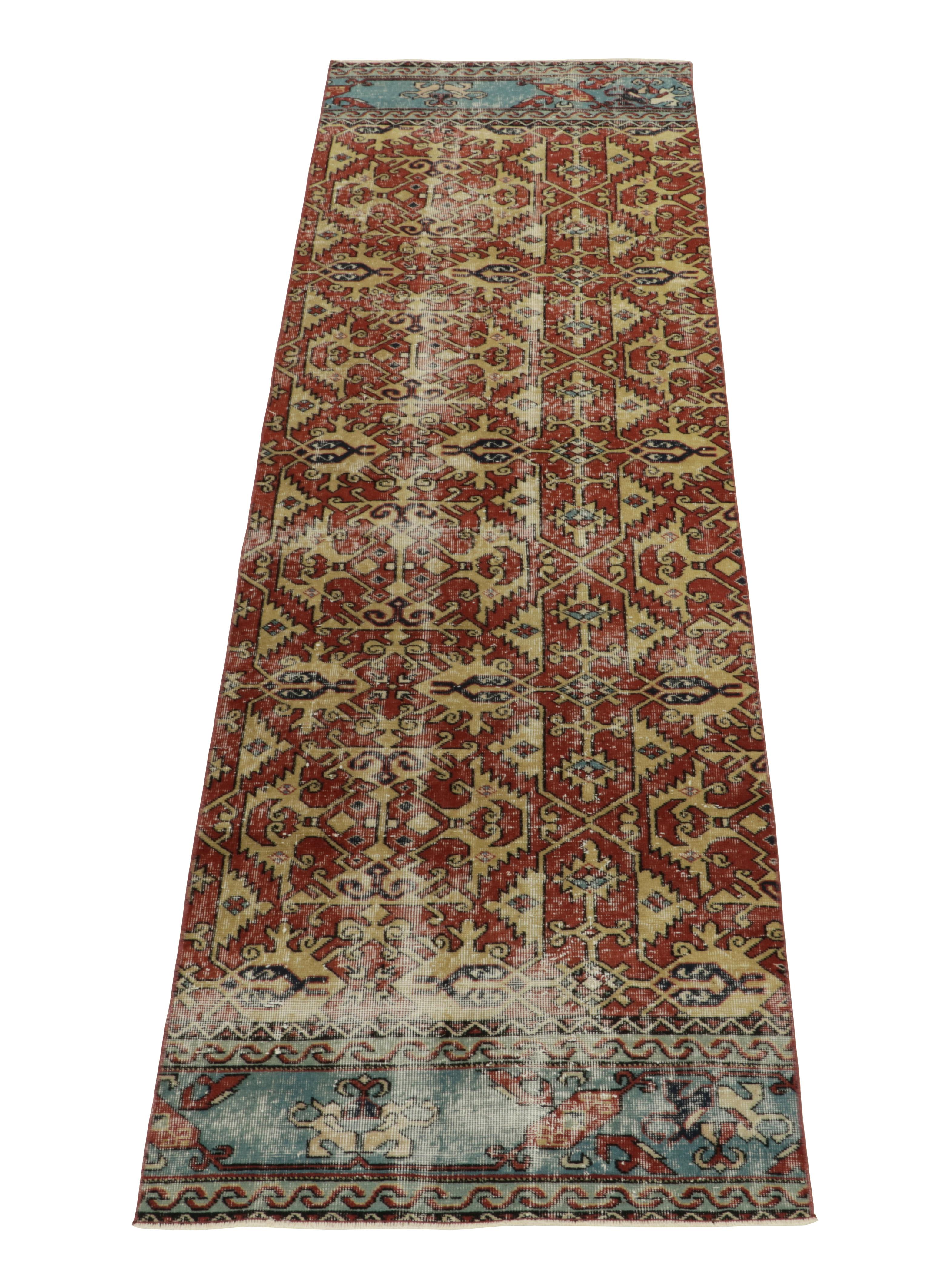 Hand-knotted in low wool pile, a 3x10 vintage runner in distressed style from the works of a revered Turkish designer. 

Originating from Turkey circa 1960-1970, the runner draws lavish inspiration from regal Anatolian geometric patterns in rust
