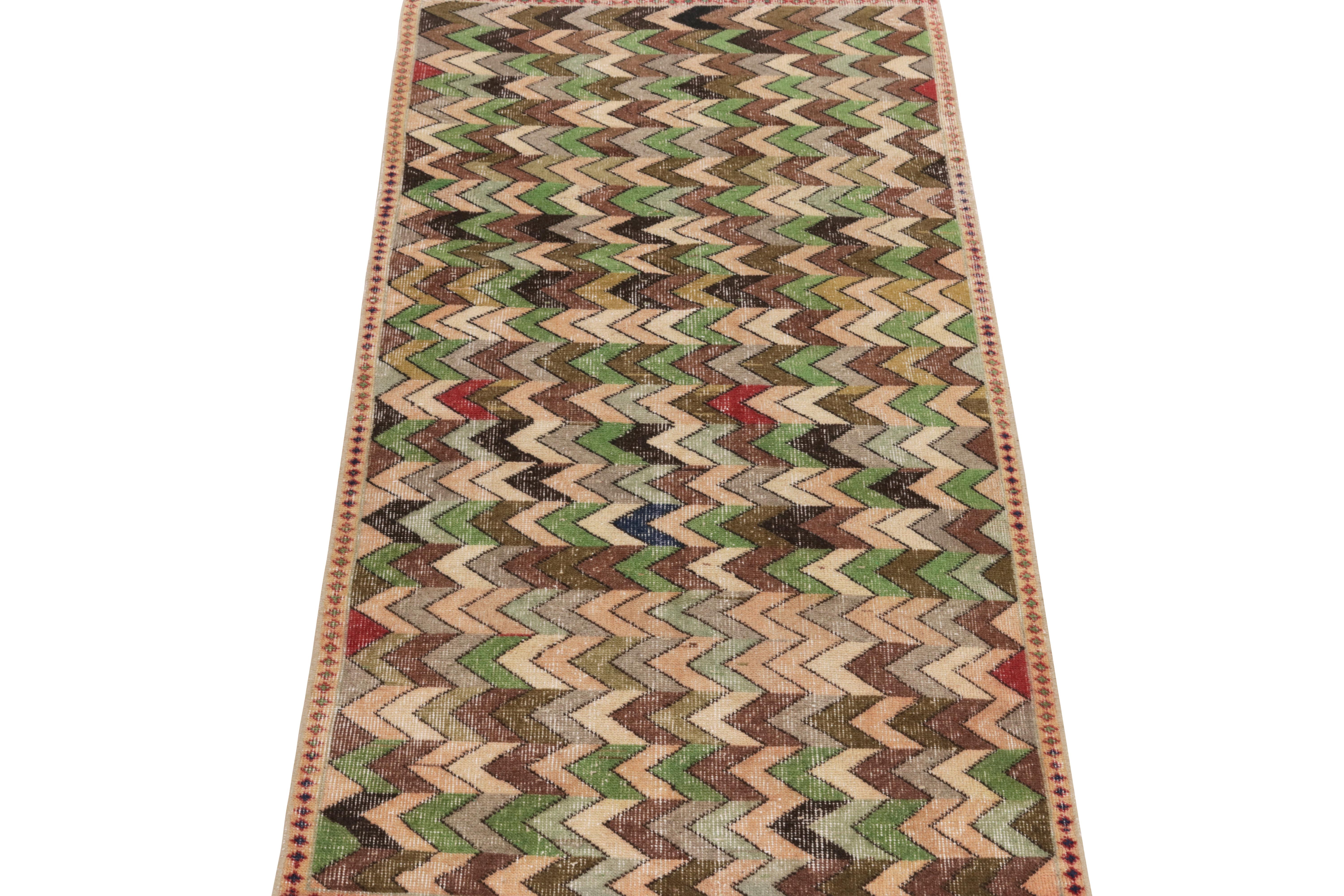 Hand-knotted in wool circa 1960-1970, a 3x6 vintage runner from a bold Turkish designer commemorated in Rug & Kilim’s Mid-Century Pasha Collection, featuring well defined chevrons in neat repetition for a gorgeous sense of movement. The pattern runs