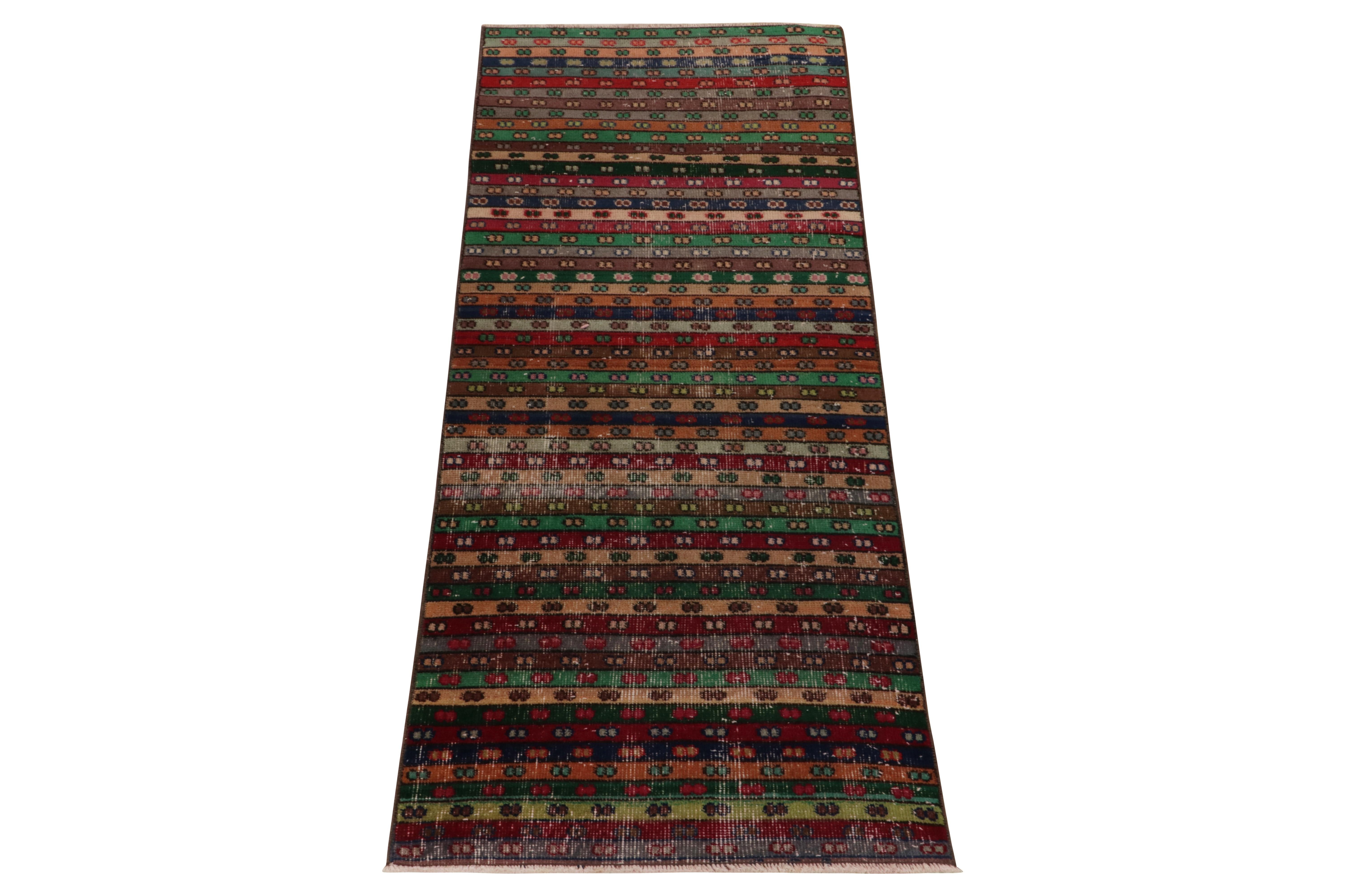 Hand-knotted in wool, a 2x6 vintage runner from a bold Turkish designer, commemorated in Rug & Kilim’s Mid-Century Pasha Collection. 

Featuring a repetitive geometric pattern in polychromatic stripes, the runner reads dextrous juxtaposition in