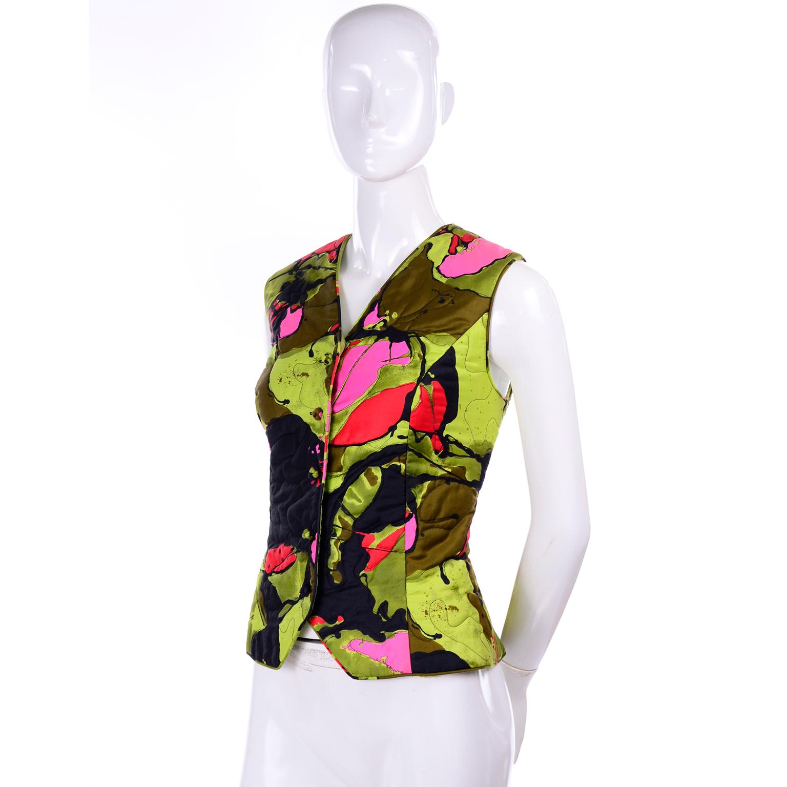 This is fun and colorful late 1960's vest from Dynasty. Wear it as a vest or as a sleeveless top, either way, it is a great piece to add to your closet! The print is an abstract floral, with splatters of army and lime green, hot pink, and red. The