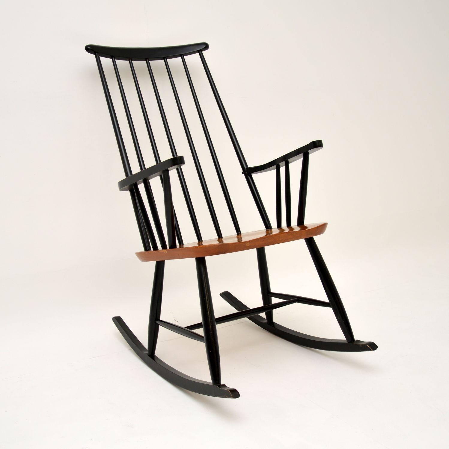 A wonderful original vintage rocking chair in solid ebonised wood, with a solid elm seat. This was made in the former Yugoslavia, it dates from the 1960’s.

This is very well made, structurally sound and comfortable. It has a fantastic design and