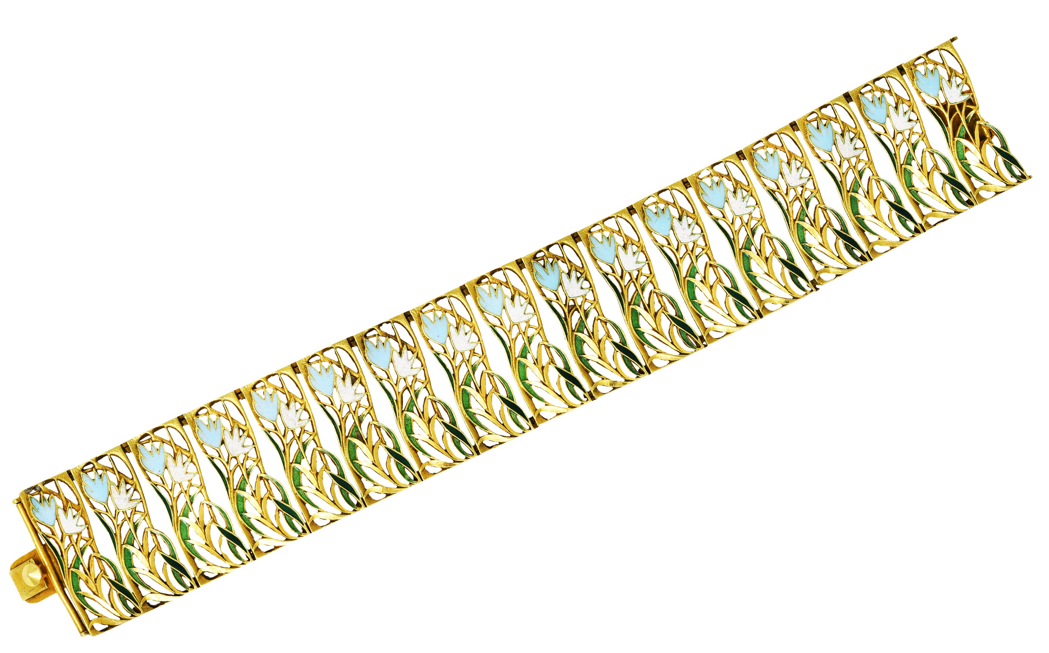 Bracelet is comprised of pierced gold panel links with flowing enamel floral motif throughout

Glossed opaque blue, opaque pink, and transparent green in color - quality consistent with age

Completed by hidden clasp

Stamped 750 and k18 for 18