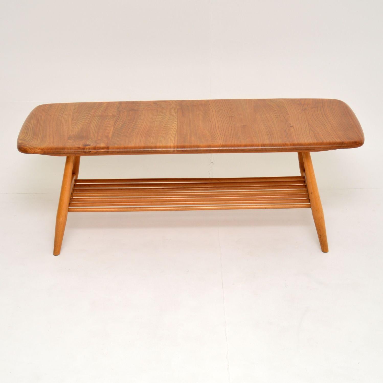 A stunning vintage ‘Windsor’ coffee table, this was made by Ercol in the 1960s-1970s.

As with all Ercol products it is extremely high quality. It is a good size, with a useful lower tier for extra storage.

The top is solid elm, with stunning