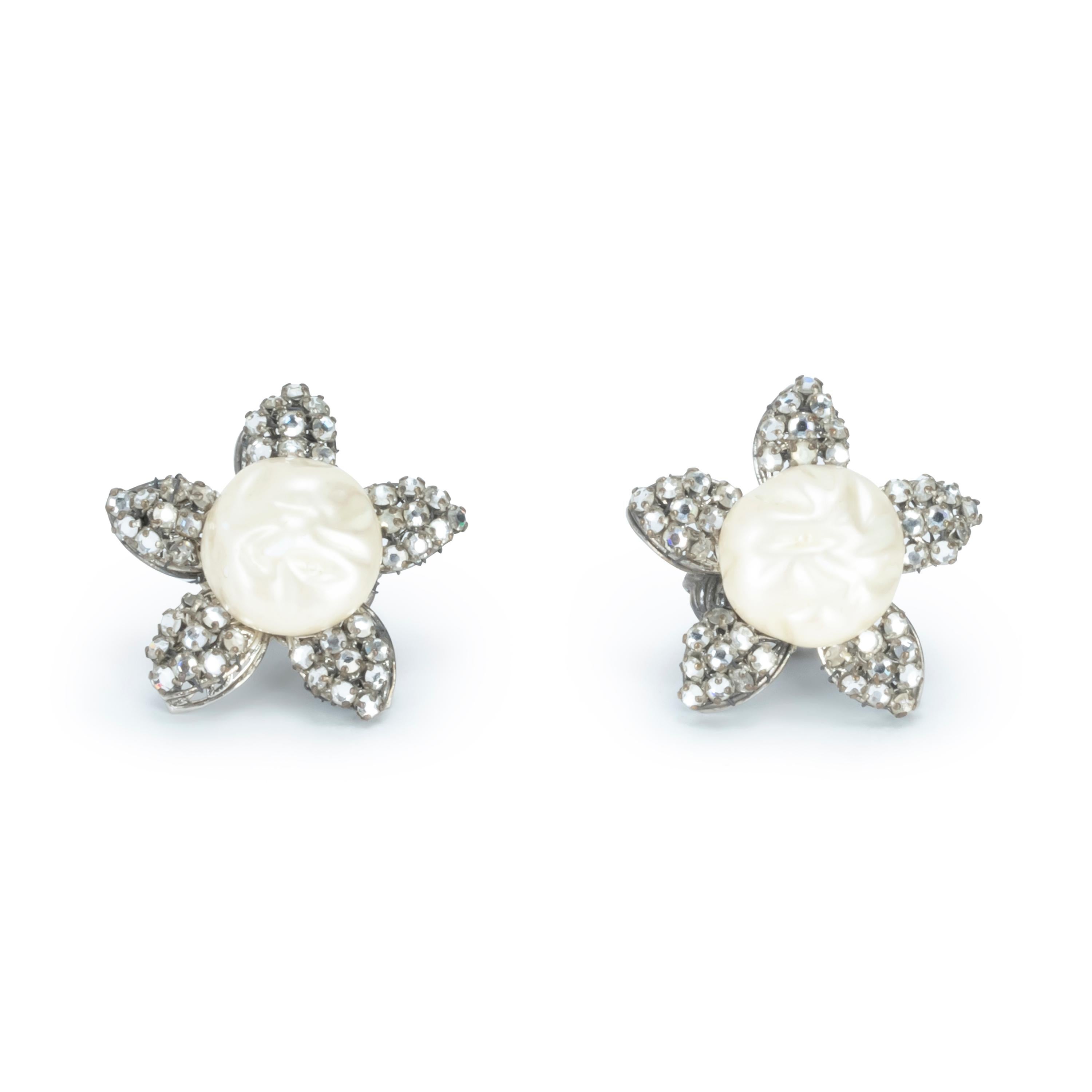 Vintage elegant and chic Flower Pearl earrings 
A classic 1960s look that is timeless, the earrings are clip ons. In fantastic condition.
Zircons are hand set pave style with button pearls.
The item is sIgned by an unknown artist and looks like it