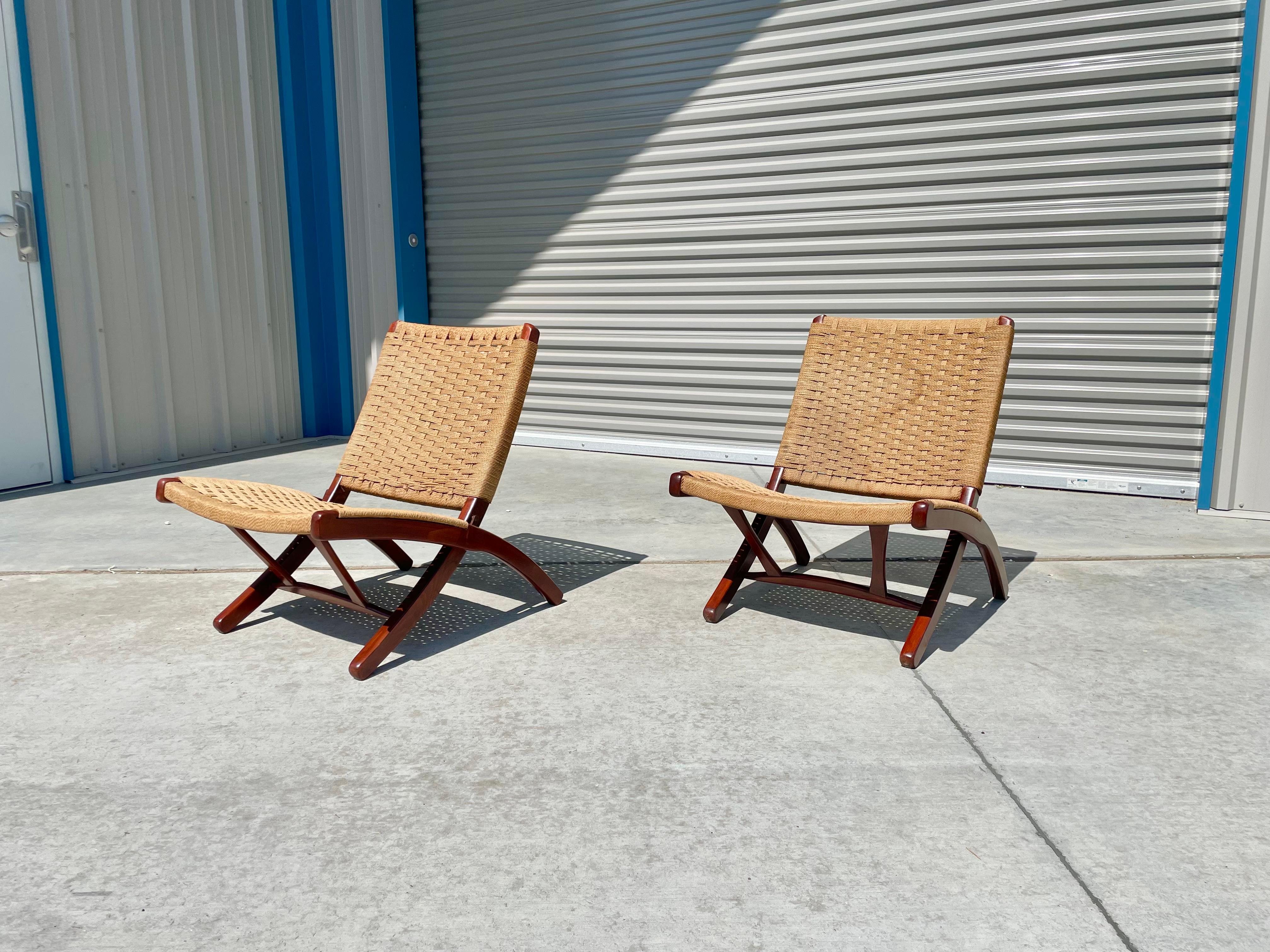 Vintage folding rope lounge chair designed and manufactured in Yugoslavia circa 1960s. These stunning chairs feature a wood frame with rope wrapped around the chairs; the rope remains taught after all these years. The chairs also fold, making them