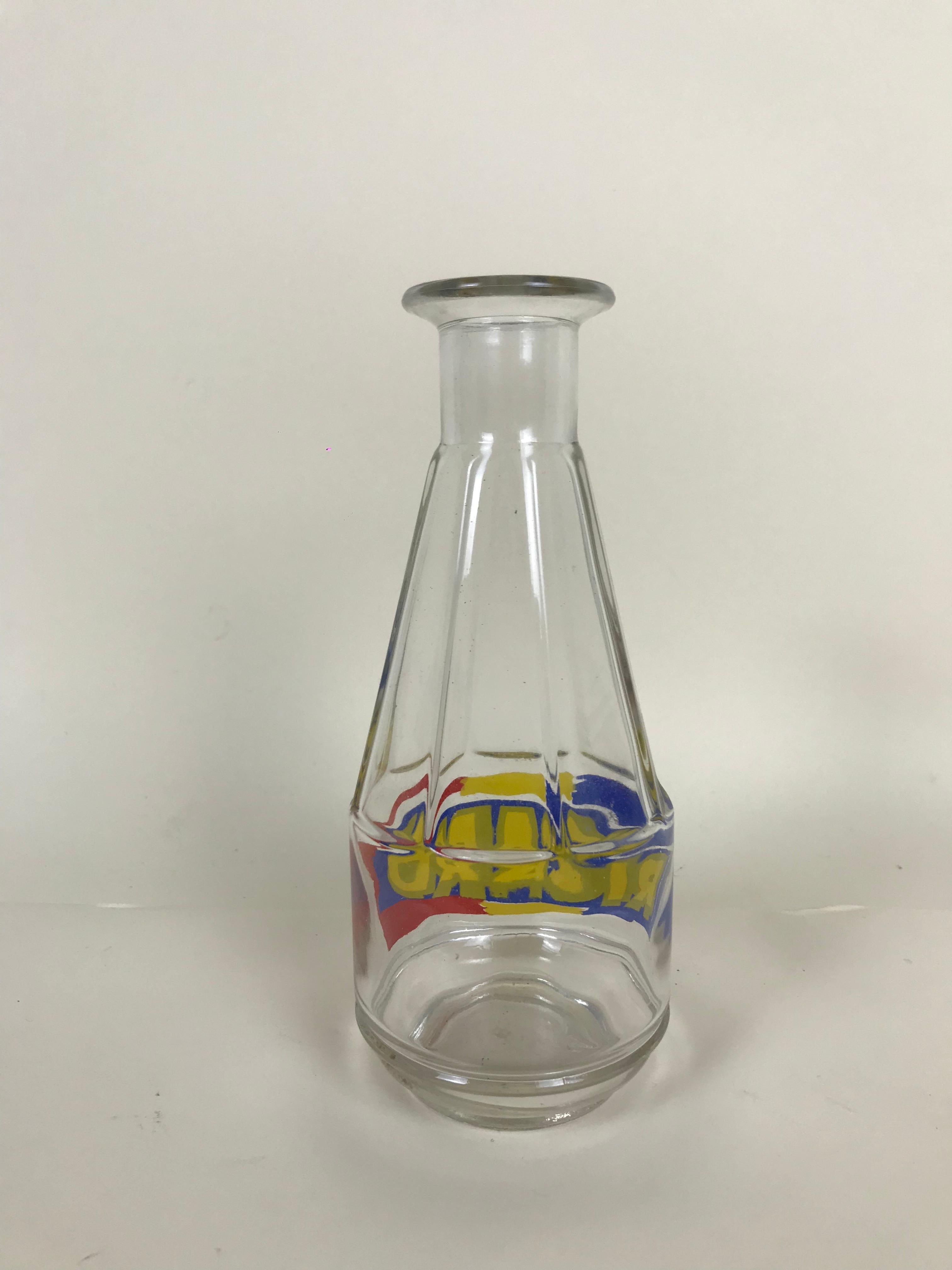 Vintage Ricard liquor decanter from mid century (1960s) French bistrò.
This liquor dispenser in transparent glass with Ricard logo in blue, yellow and red is a very chic addition to a rétro barware collection.

Collector's note:

Pernod Ricard
