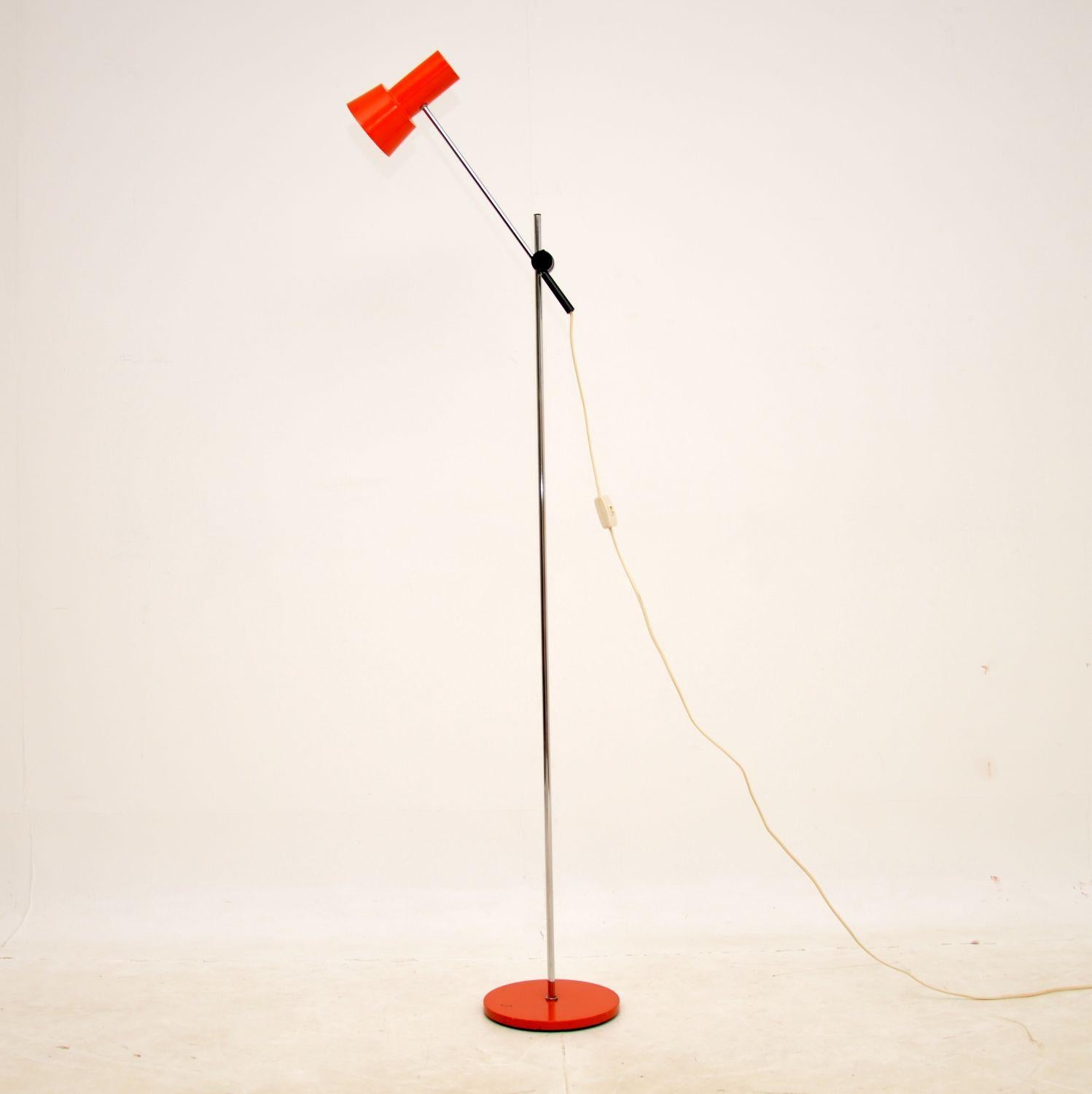 A very stylish and well made vintage floor lamp in chrome, with a deep orange painted shade and base. This was made in France, it dates from the 1960-70s.

It is of superb quality and has a beautiful design. The angle can be adjusted to varying