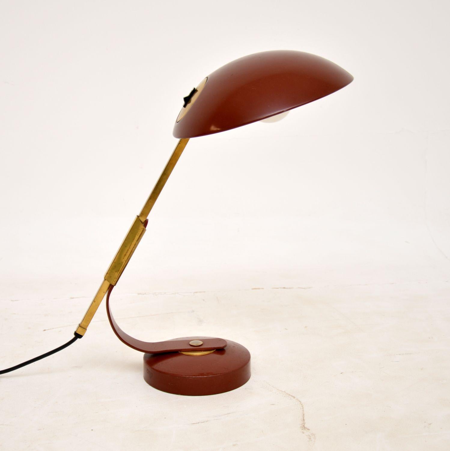 A very stylish and well made vintage desk lamp by Solere, Paris. This was made in France in the 1960’s, it was designed by Ferdinand Solere.

It is of amazing quality, it is finished in scarlet red enamel metal and brass. It has a gorgeous design,