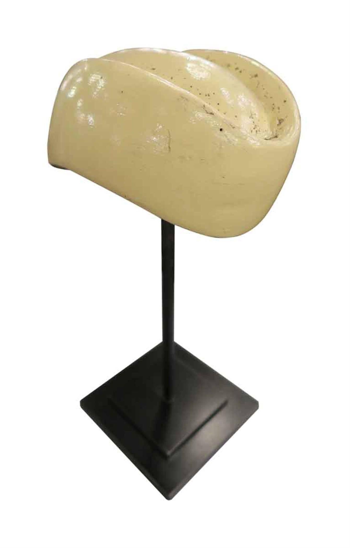1960s vintage French tan hat mold sculpture on a black steel stand. This can be viewed at one of our New York City locations. Please inquire for the exact address.