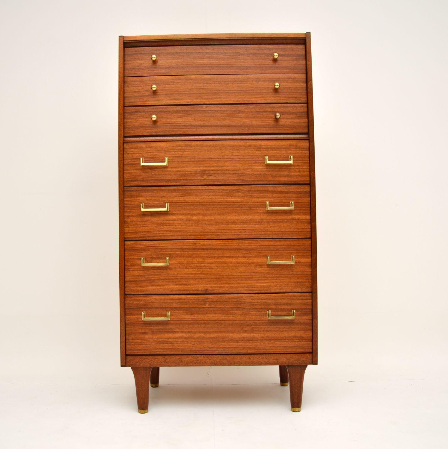 A stunning vintage tallboy chest of drawers in walnut. This was made in England by G- Plan, it dates from the 1960’s.

This is a rare model of exceptional quality, it has stunning walnut grain patterns throughout. The handles and feet caps are