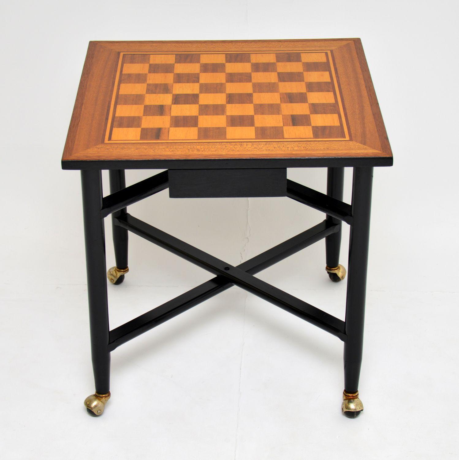 A stylish and very well made vintage chess table, this dates from the 1960s. The chessboard top is veneered in walnut, satin wood and mahogany. The base is solid ebonised wood, and there is a drawer on either side for storing chess pieces.

The