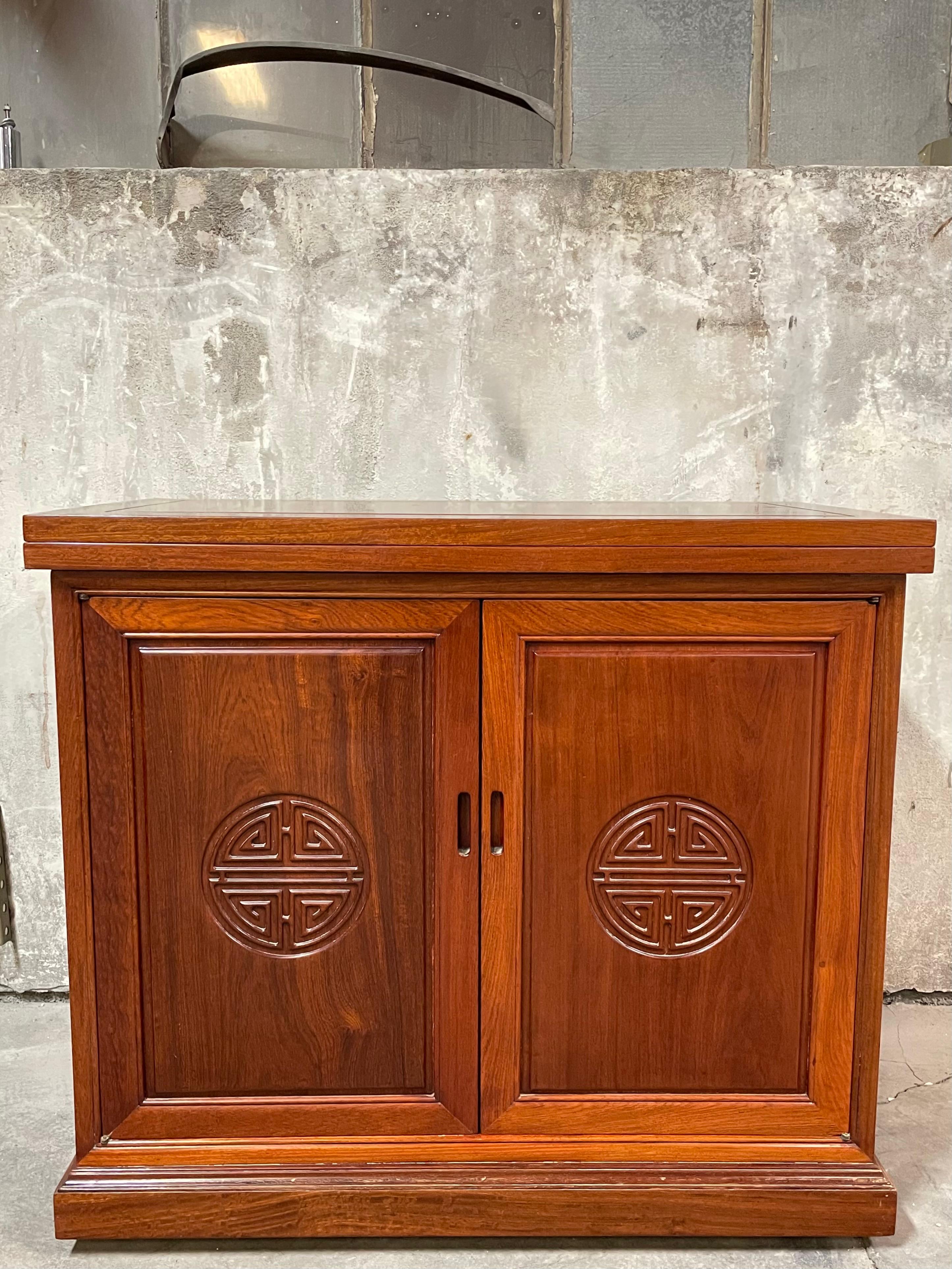 Fabulous mid century flip top server/bar by George Zee of Hong Kong. From the estate of an executive of the Ford Foundation. Purchased in Hong Kong while on business in the 1960’s.
Exceptional craftsmanship, solid as a rock. Double doors open to