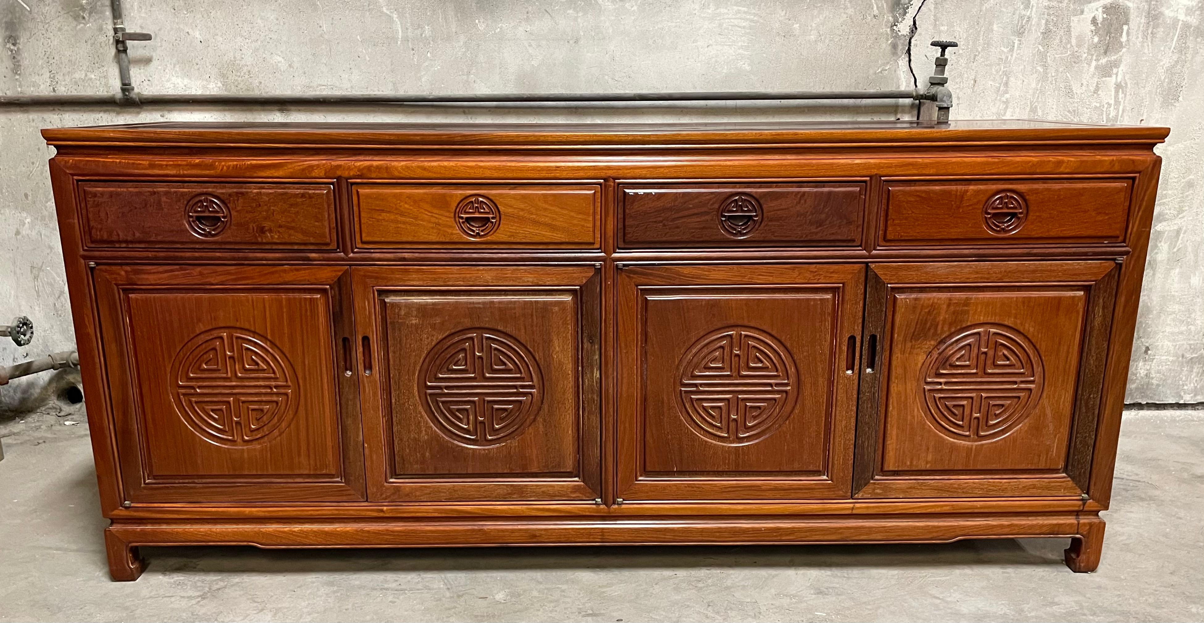 Handsome solid teak Chinoiserie Hollywood Regency buffet or credenza by George Zee. It is in fabulous vintage condition. It has no outstanding flaws that we have detected. It does have some small age appropriate coloration. Please see photos. Circa